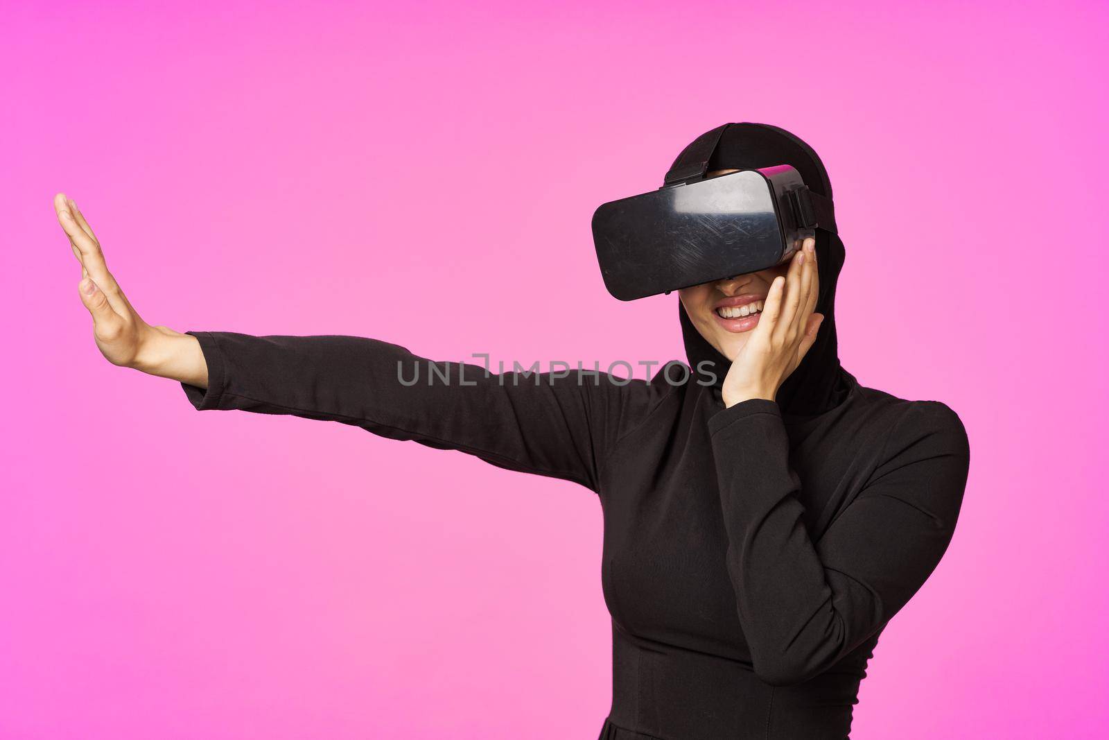 muslim woman wearing virtual reality glasses entertainment technology device. High quality photo