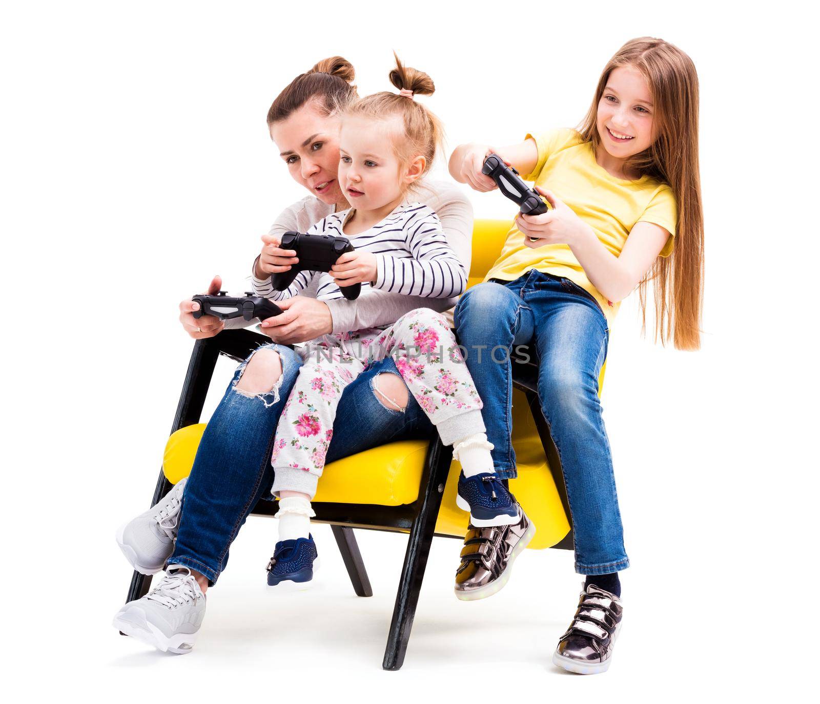 Mom and daughters spending time on computer games on playing console, using joystick