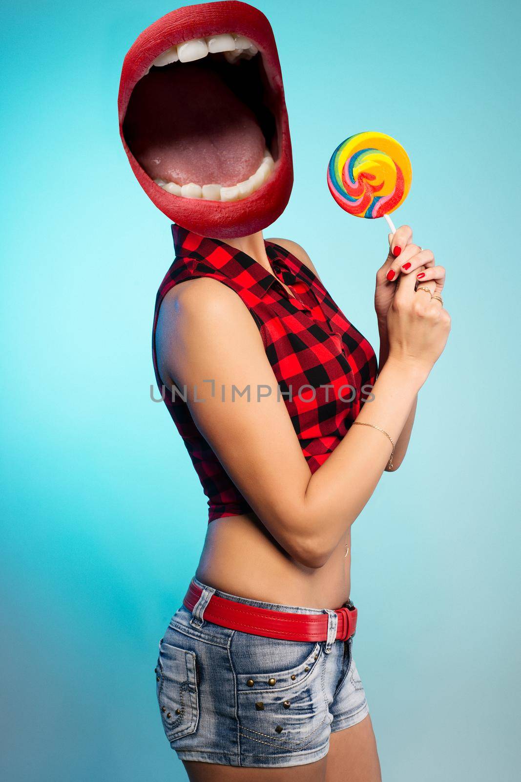 Collage of open mouth instead of a woman's head with lollipop, dressed in pin-up style.