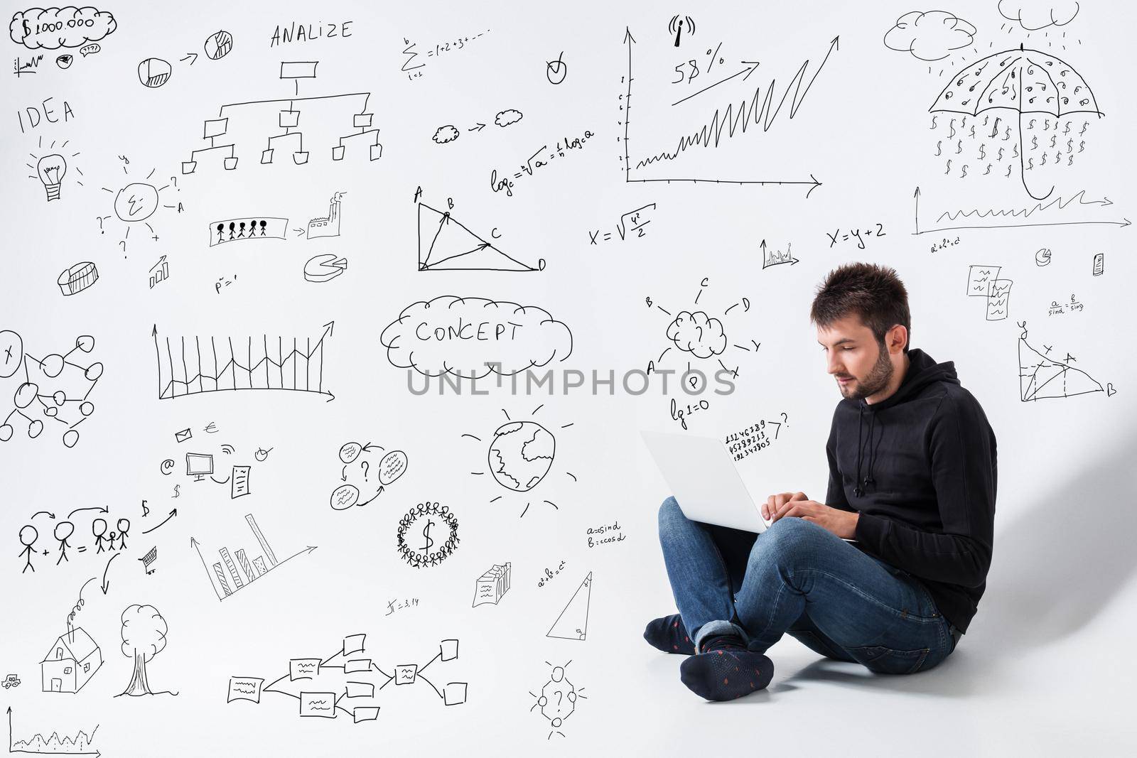 a young man in casual clothes working on a laptop. concept