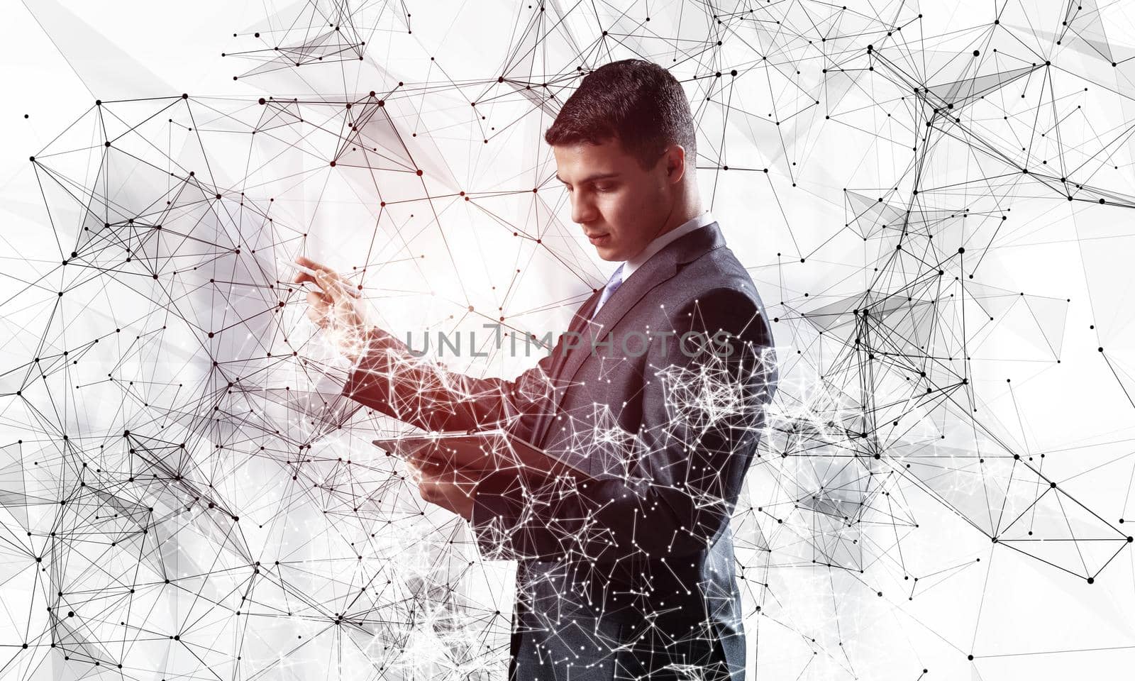 Handsome manager pointing on abstract network composition. Man in business suit on white background. Mixed media with virtual network. Professional business assistance, financial maintenance support
