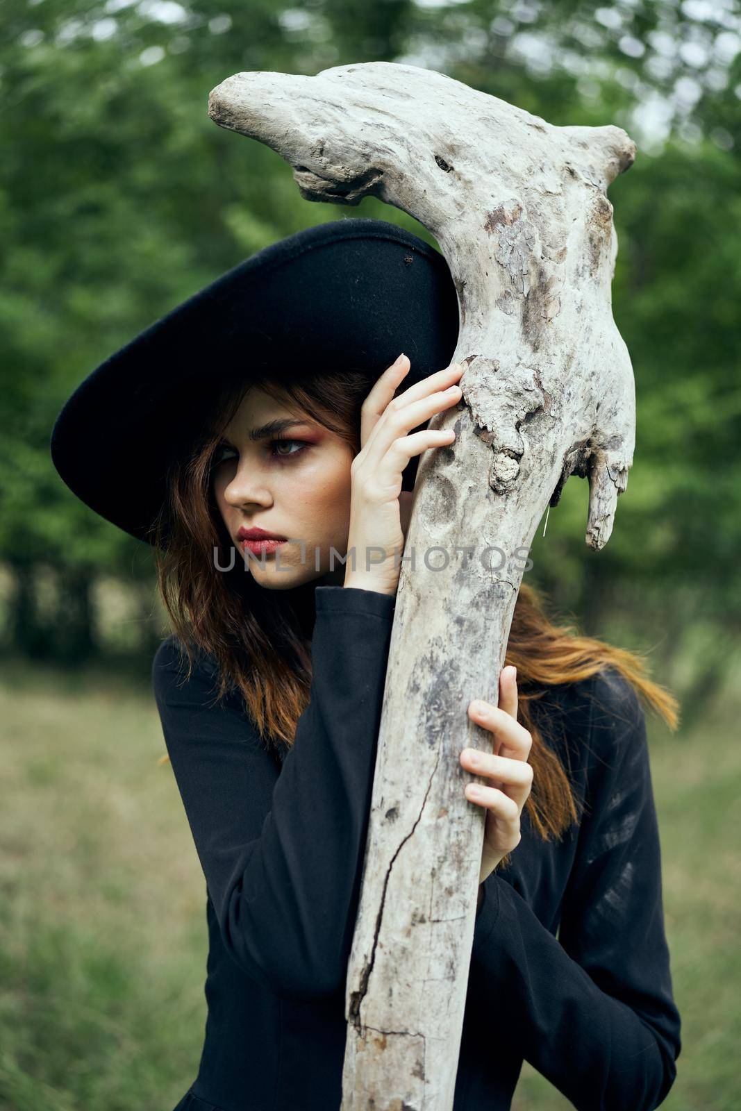 woman in witch costume halloween forest staff gothic. High quality photo