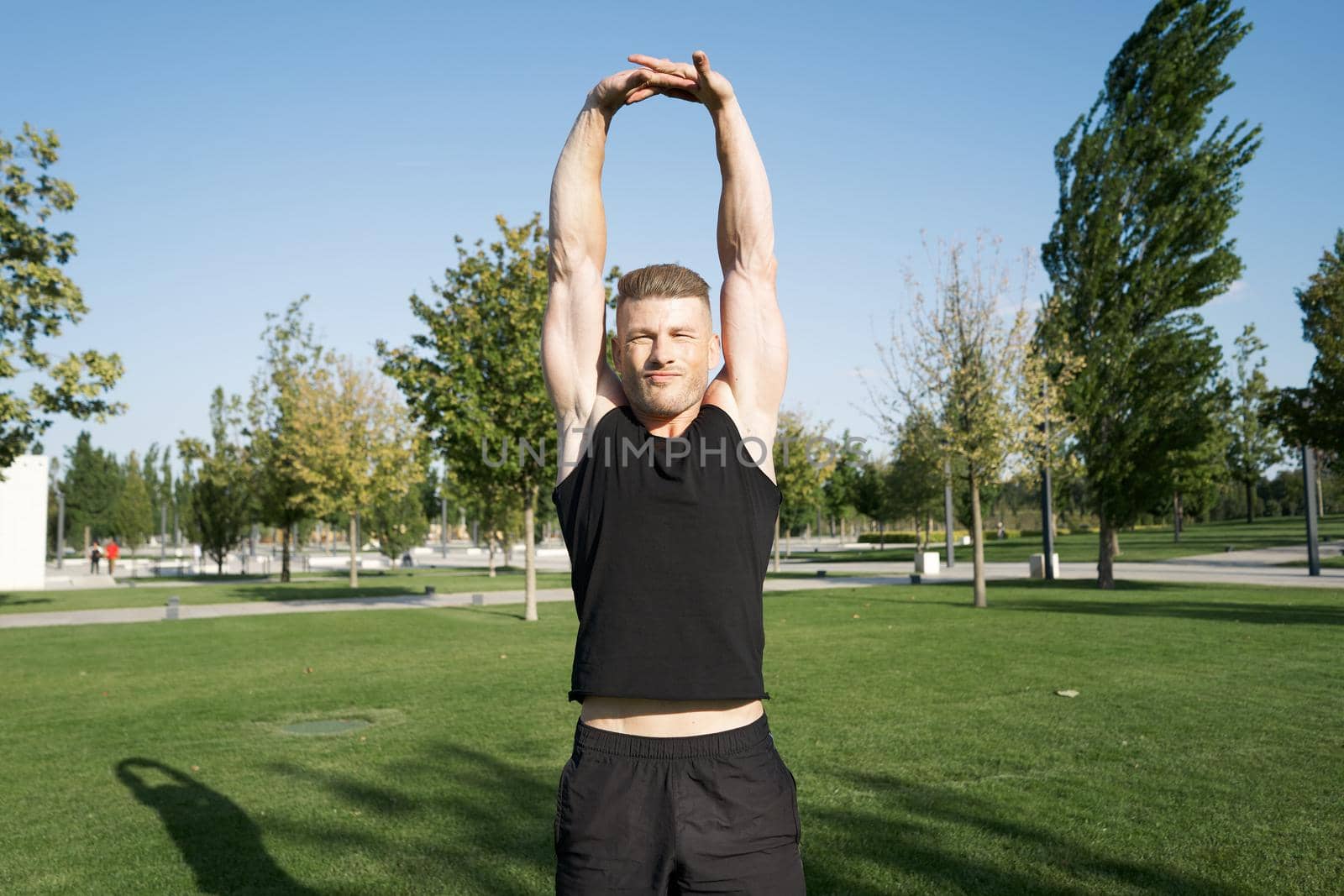 beefy man and athlete in the park during summer workout. High quality photo