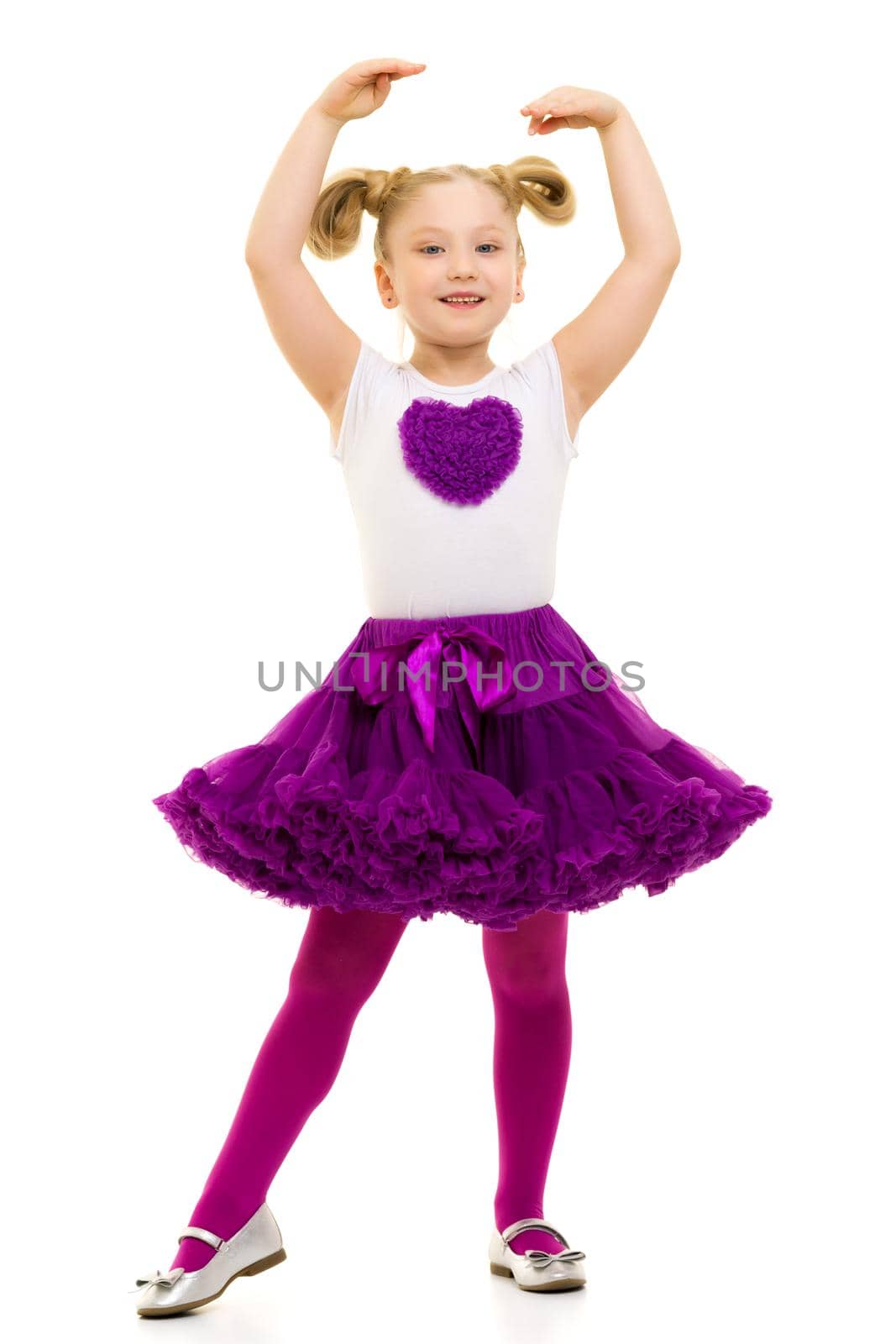 A cheerful little girl is shopping in a store with large, multi-colored paper bags. The concept of holidays, advertising sales. Isolated on white background.