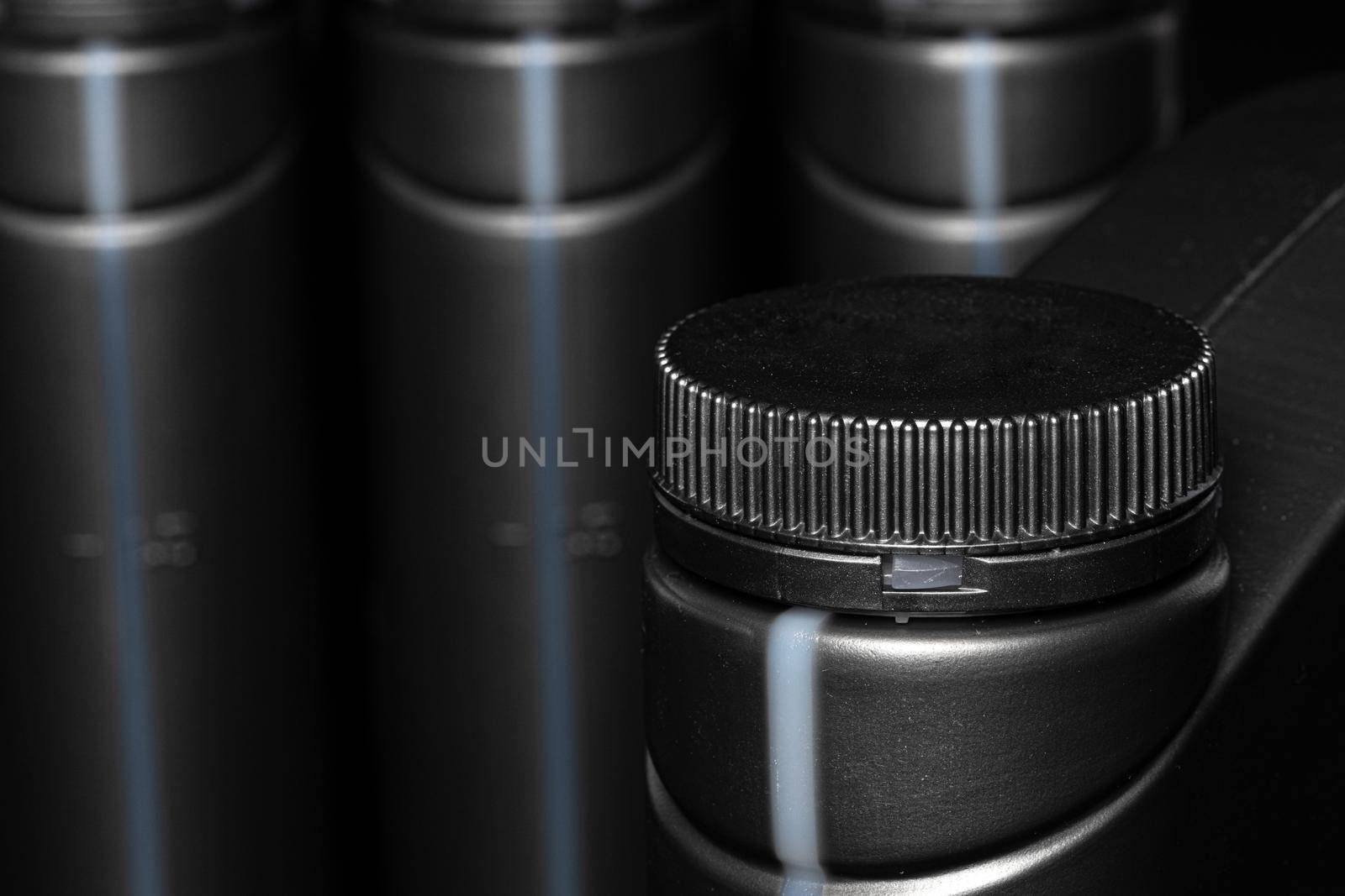 Engine oil bottle on black background.