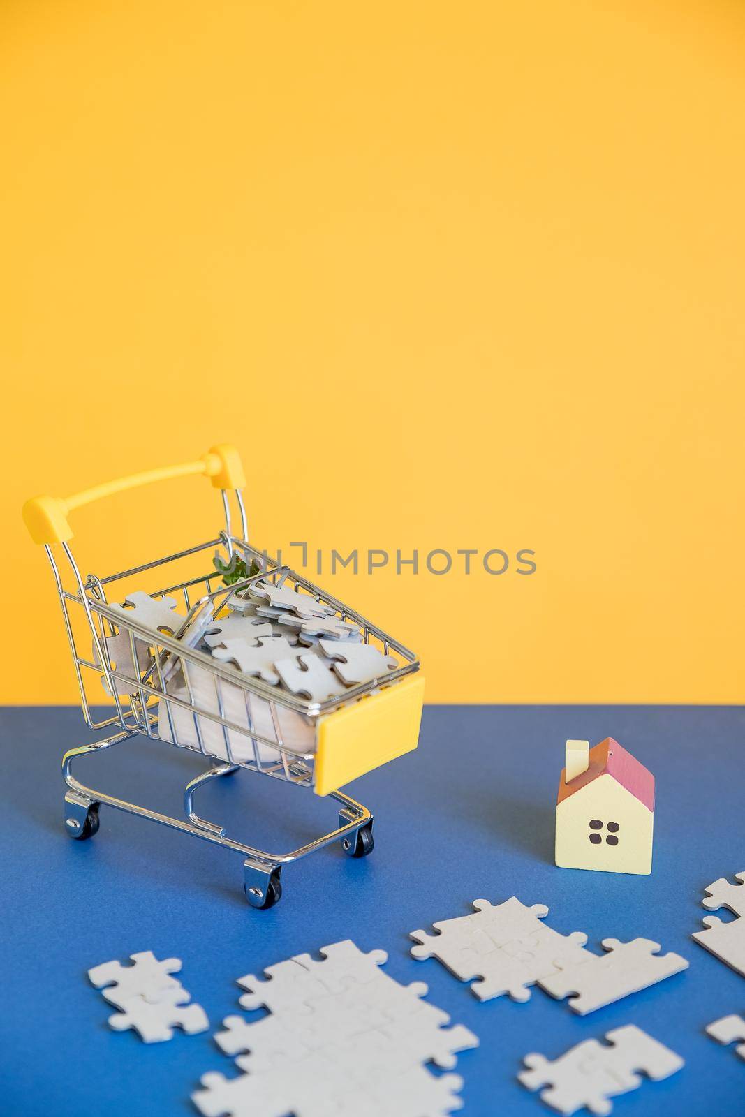 Shopping cart with small house,shopping, rent, loan, mortgage, eco district housing concept.
