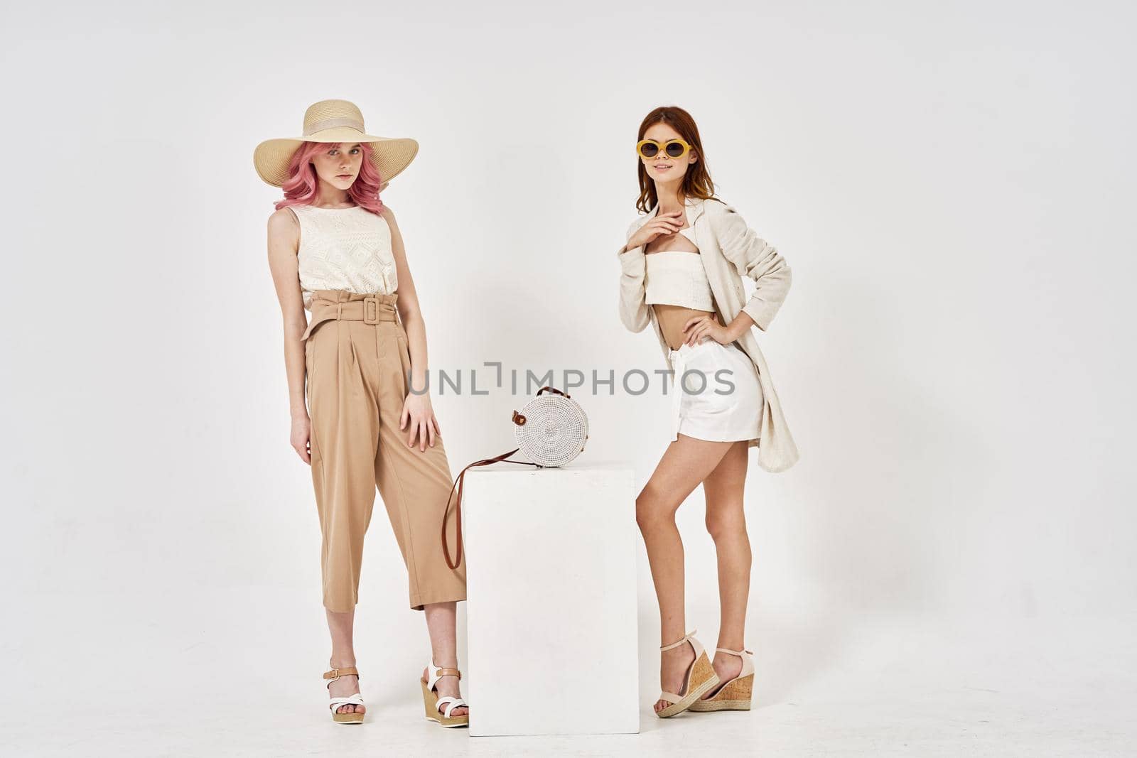 two women in fashionable clothes posing model decoration. High quality photo