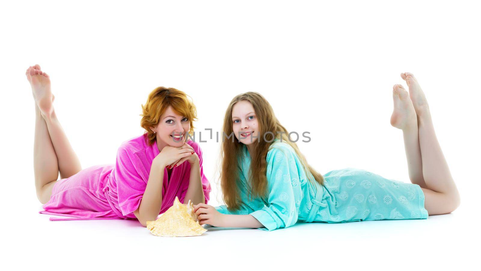 Daughter and mother in bathrobes posing in the studio. The conce by kolesnikov_studio