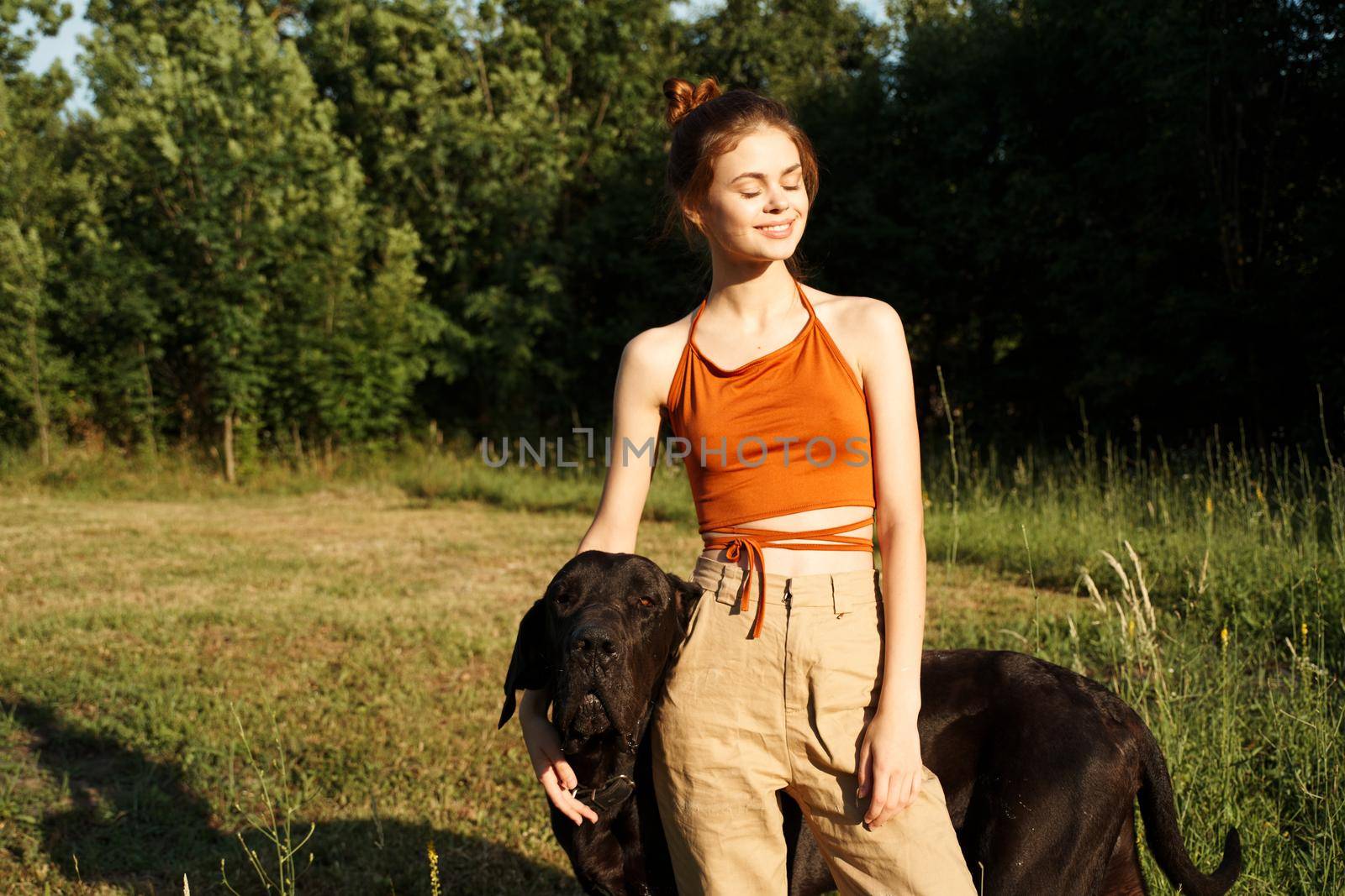 Cheerful Woman and a dog in the nature games Friendship by Vichizh