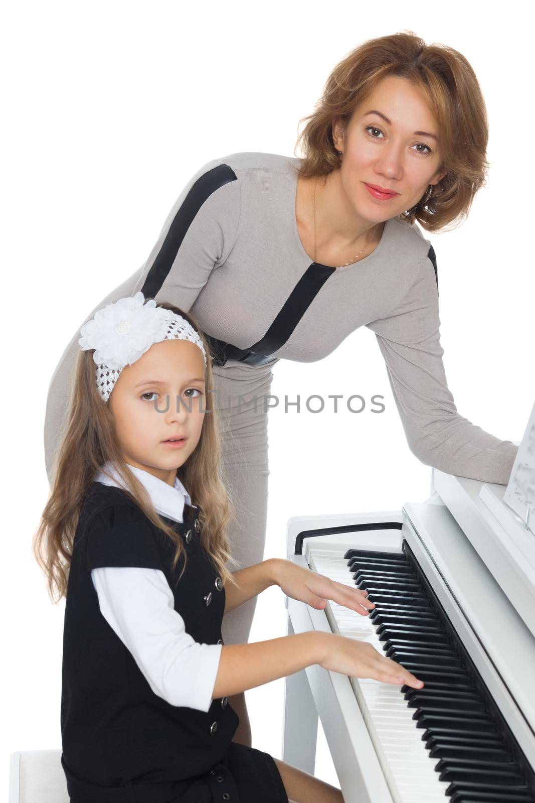 Mother and daughter learning to play piano - Isolated on white background