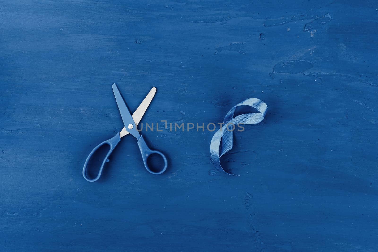 Tayloring accessories on classic blue background, top view. Close up.