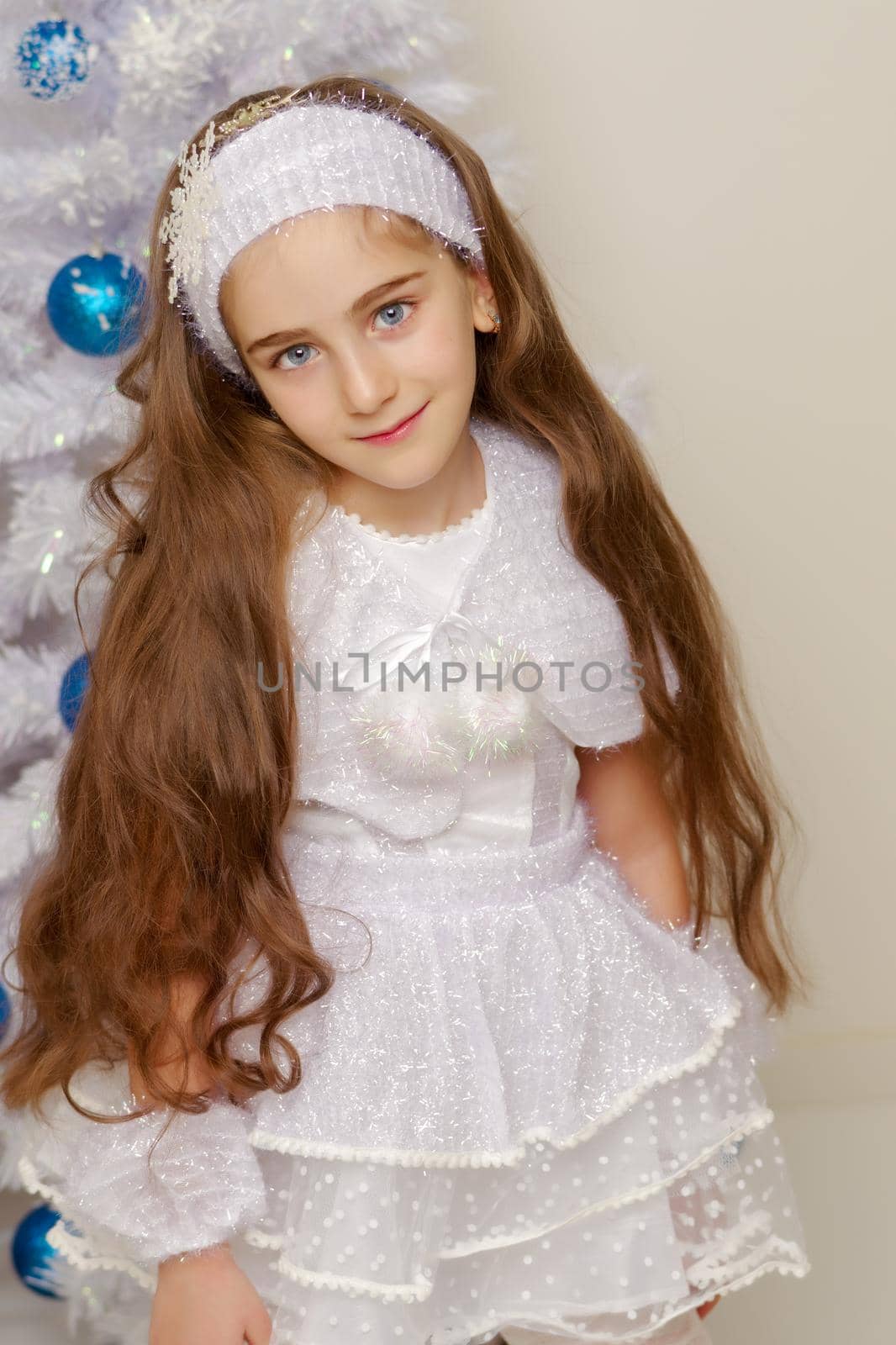 Beautiful little girl near the Christmas tree. by kolesnikov_studio