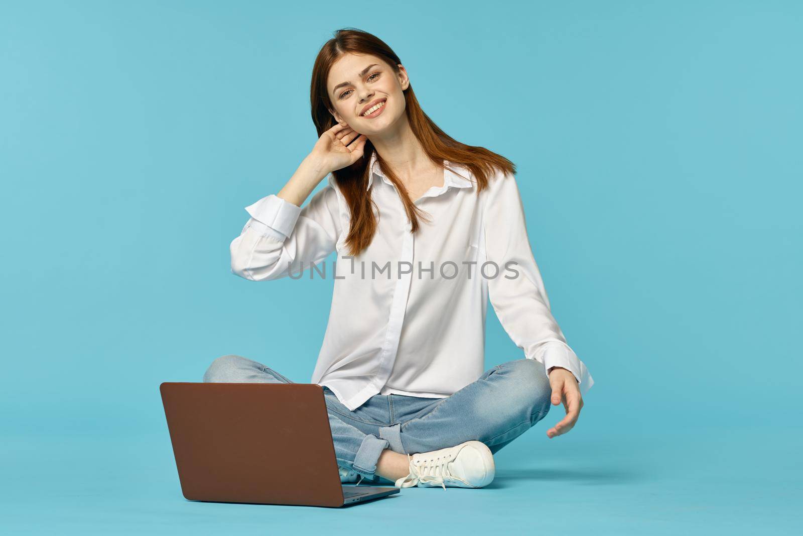 woman with laptop learning internet online education blue background by Vichizh