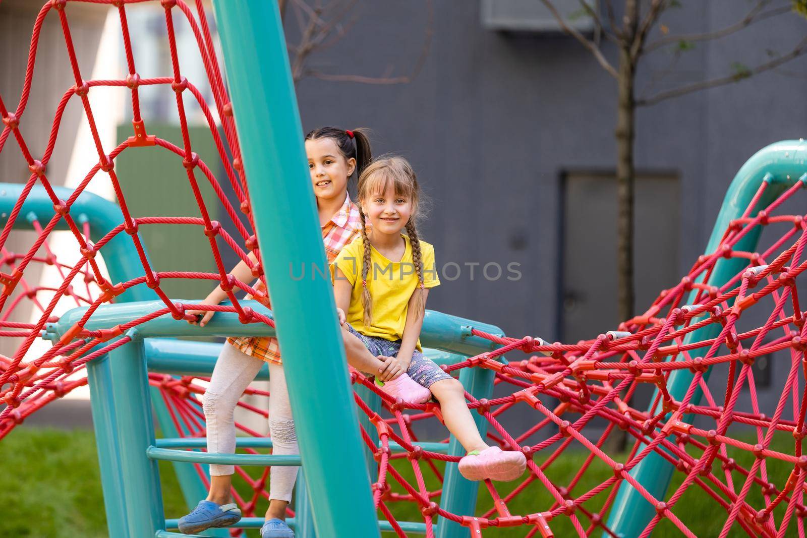 Happy children playing outdoors, children on the playground by Andelov13