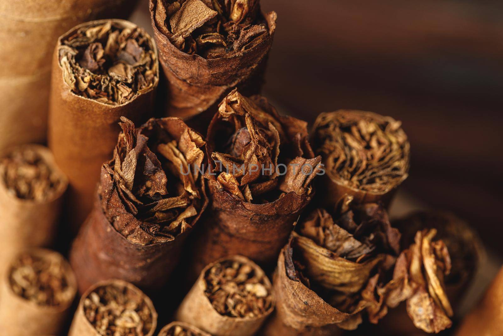 Pile of new cuban cigars close up on wooden table