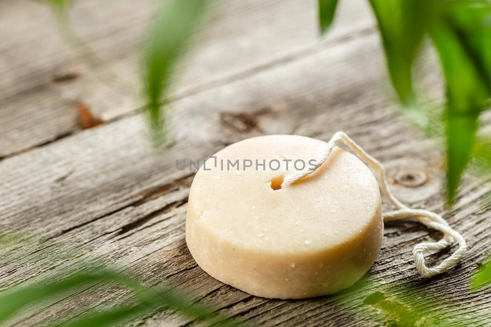 Shampoo bar, natural herbal soap or laundry soap on wooden background. Sustainable eco friendly product. Zero waste bathroom.