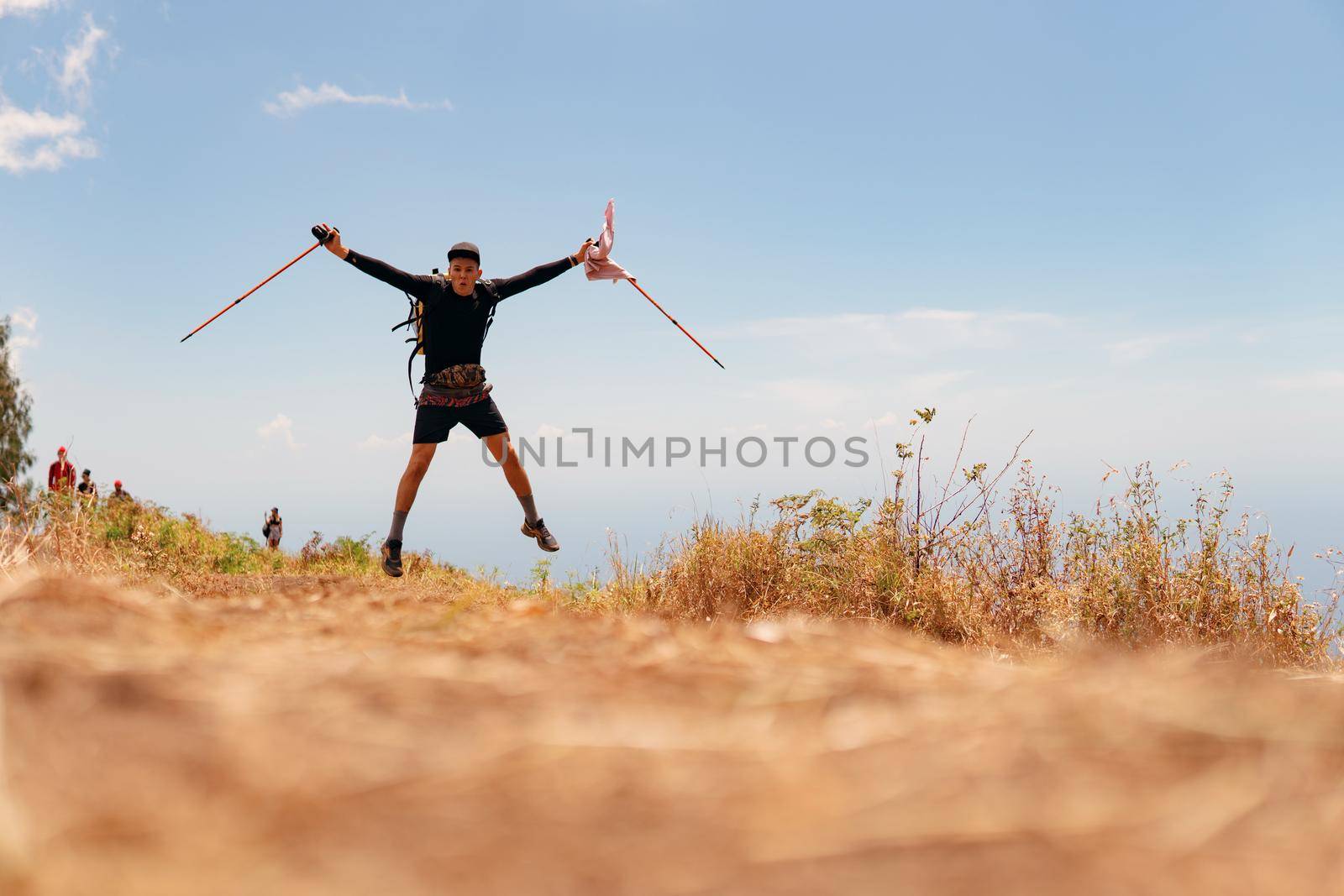 a man walks trekking in the mountains by Alexzhilkin