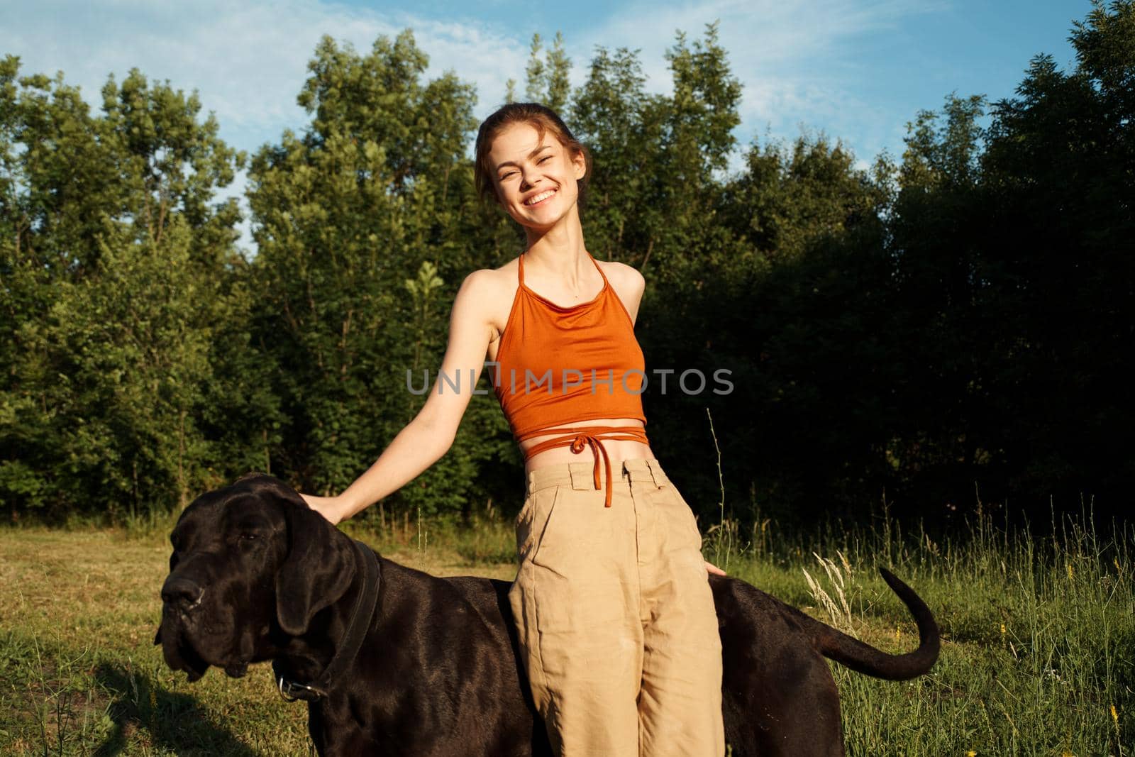 cheerful woman outdoors with dog and fun nature by Vichizh