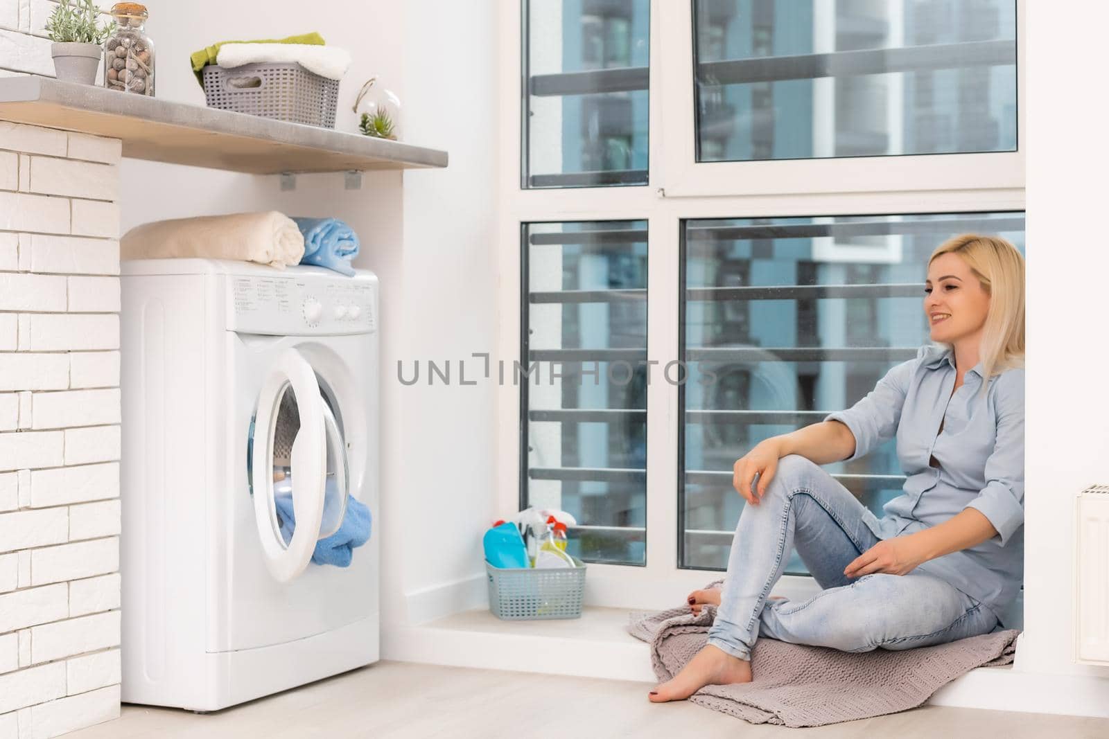 Housework, young woman doing laundry