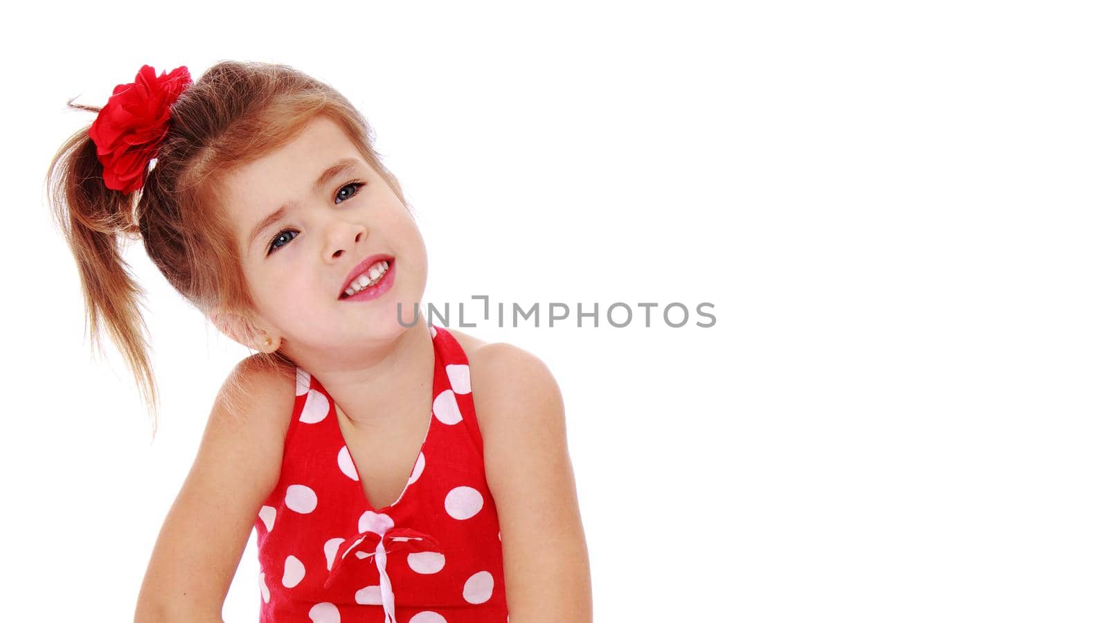 Beautiful little girl posing in the studio. Children's emotions concept. Close-up. Isolated on white background.