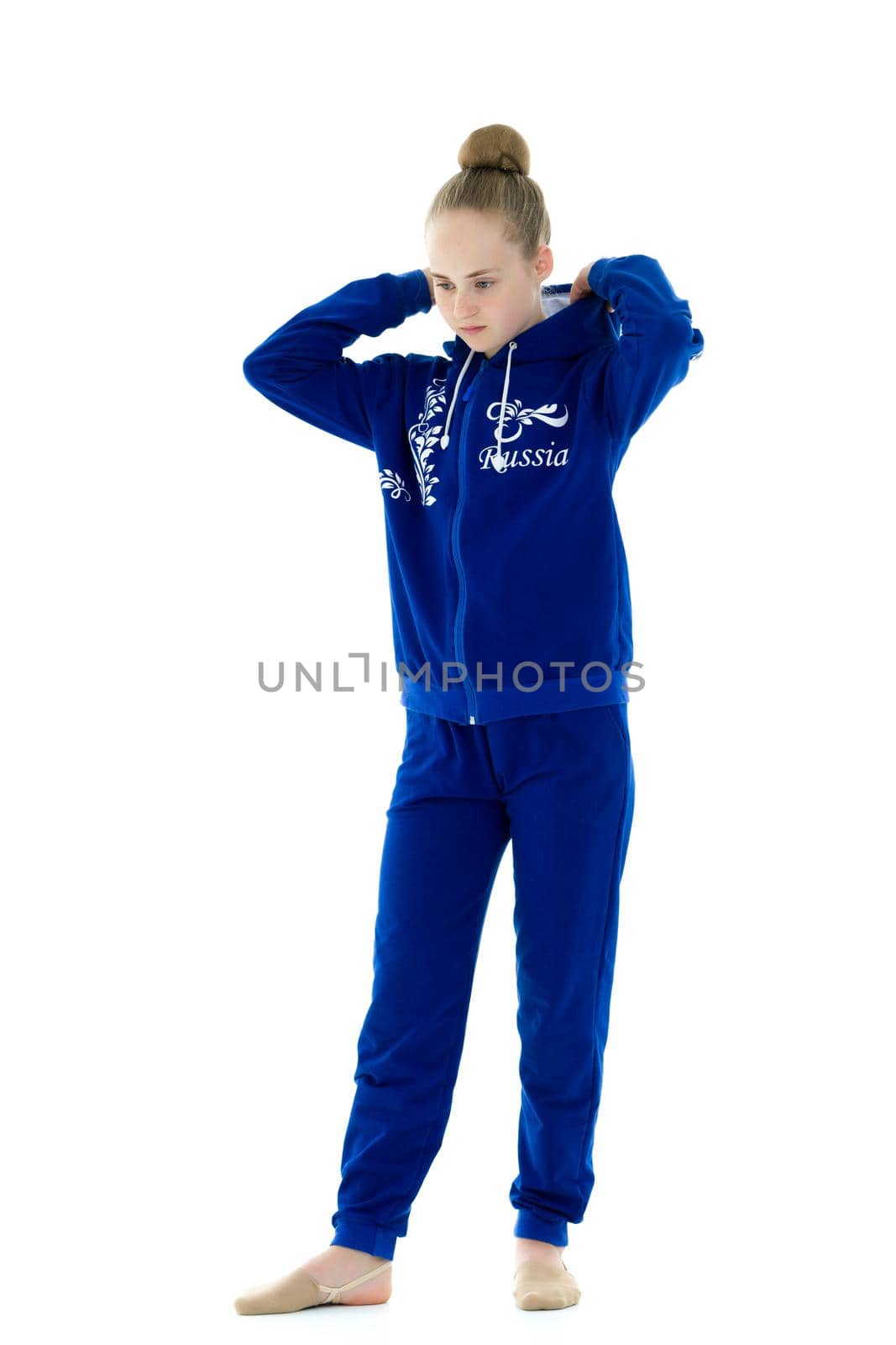 Portrait of a gymnast girl in a tracksuit. Isolated on white background