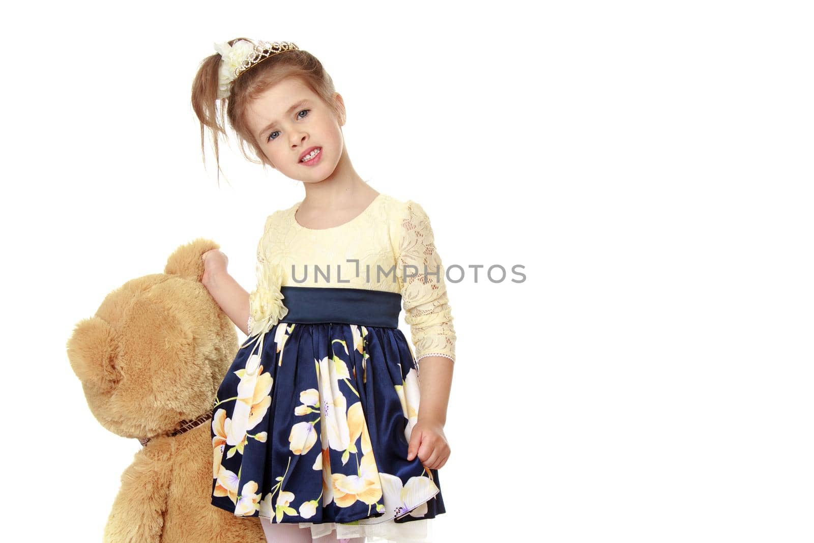 Beautiful little girl posing in the studio. Children's emotions concept. Close-up. Isolated on white background.