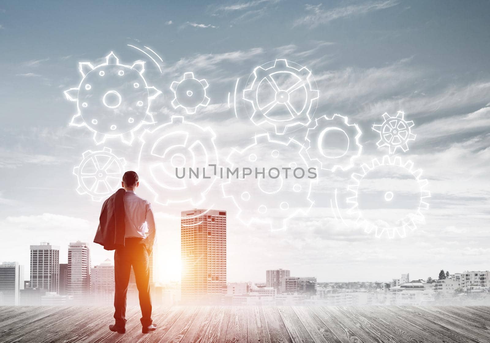 Back view of businessman looking at modern city and drawn gear mechanism