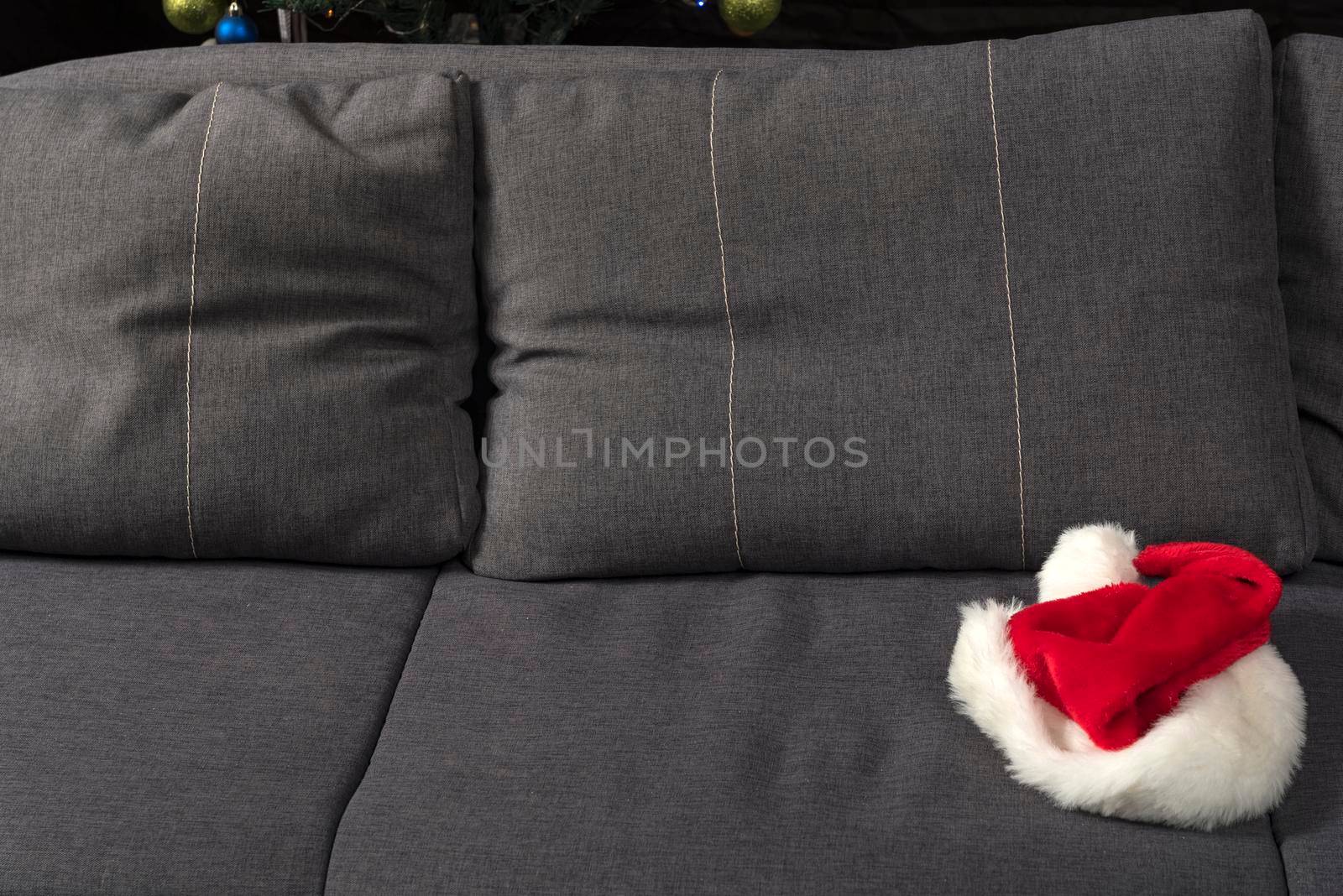 Santa hat on sofa. New Years Eve is over concept.