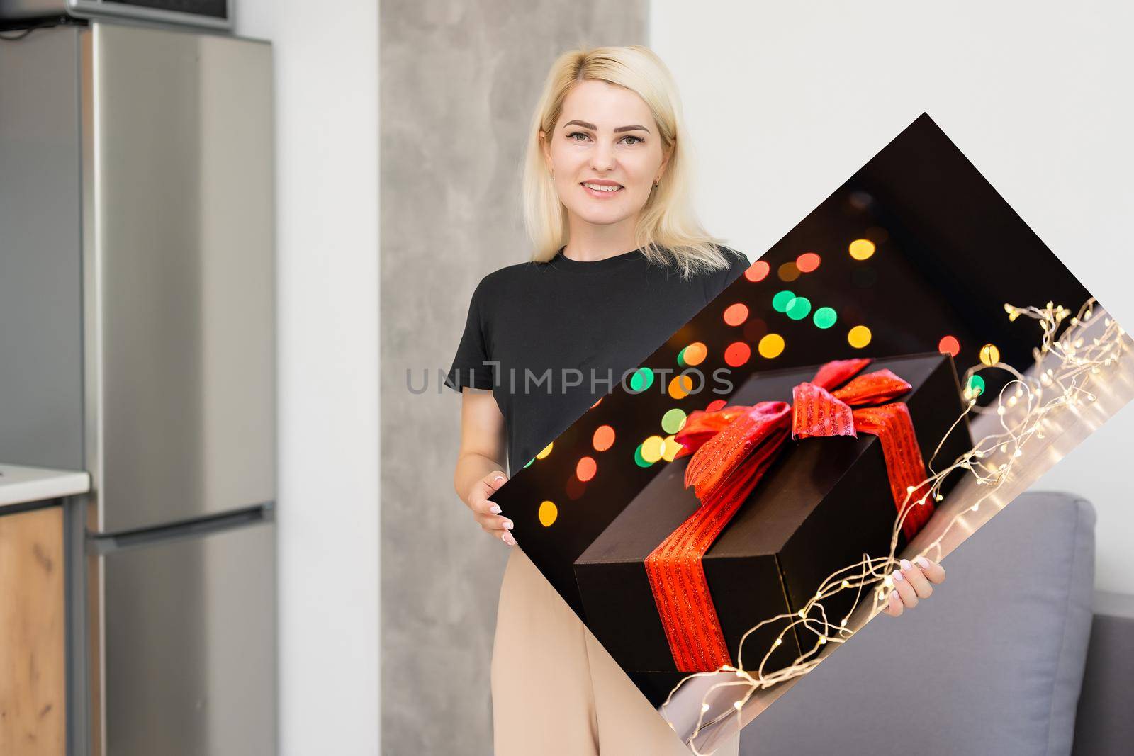 woman holding a photo canvas with a picture of christmas.