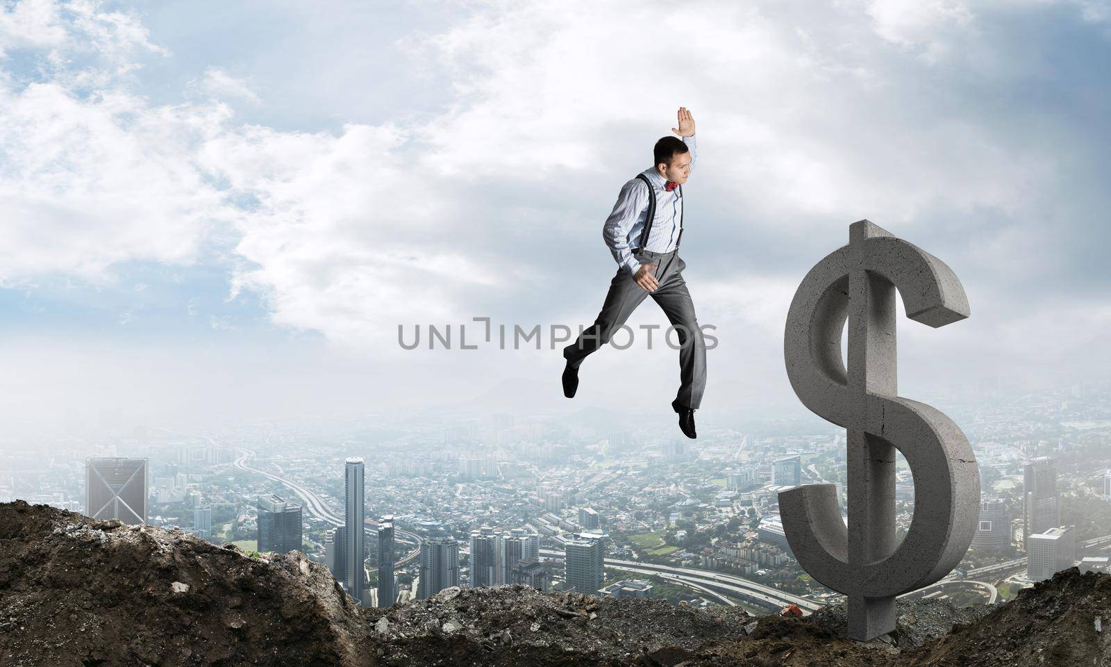 Jumping businessman in smart casual wear crashing big dollar symbol with city view on background.
