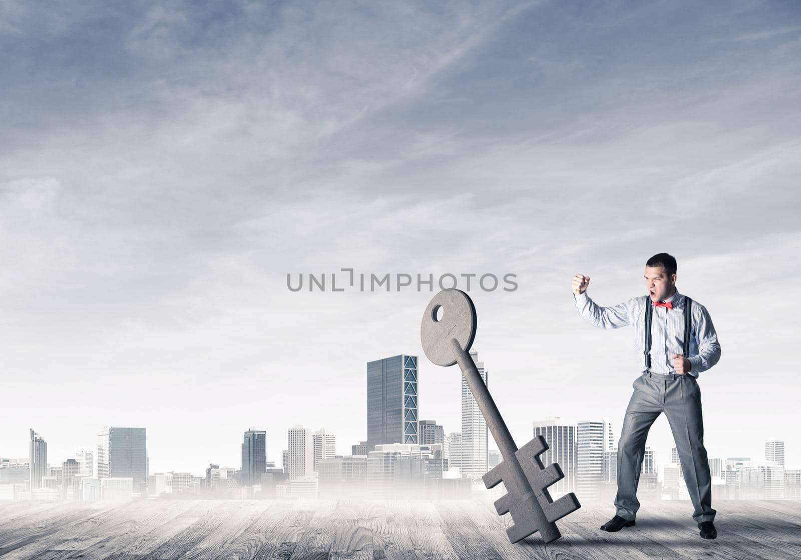 Determined businessman against modern cityscape breaking with fist stone key figure