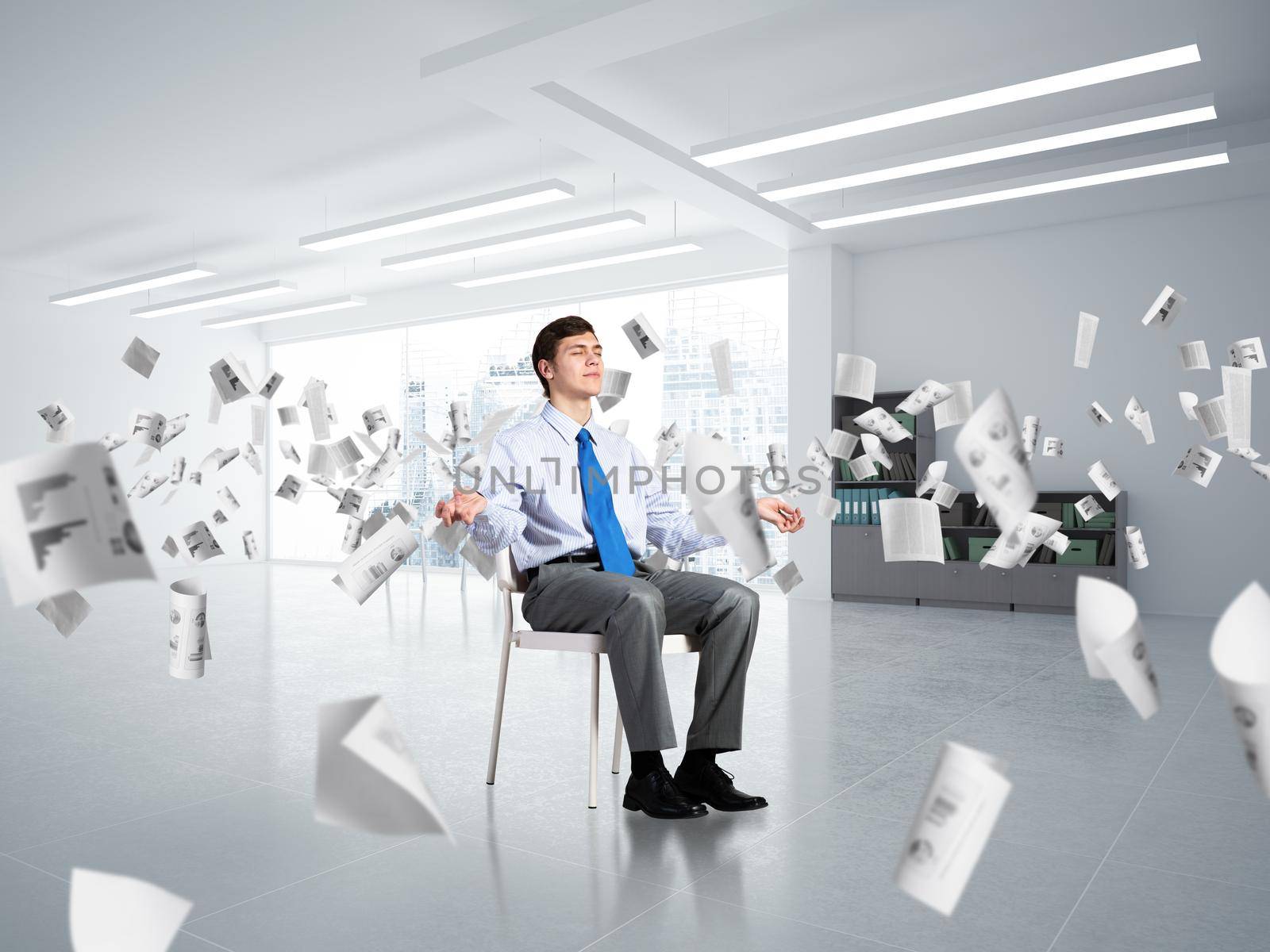 young businessman in the office meditates. concept of creativity