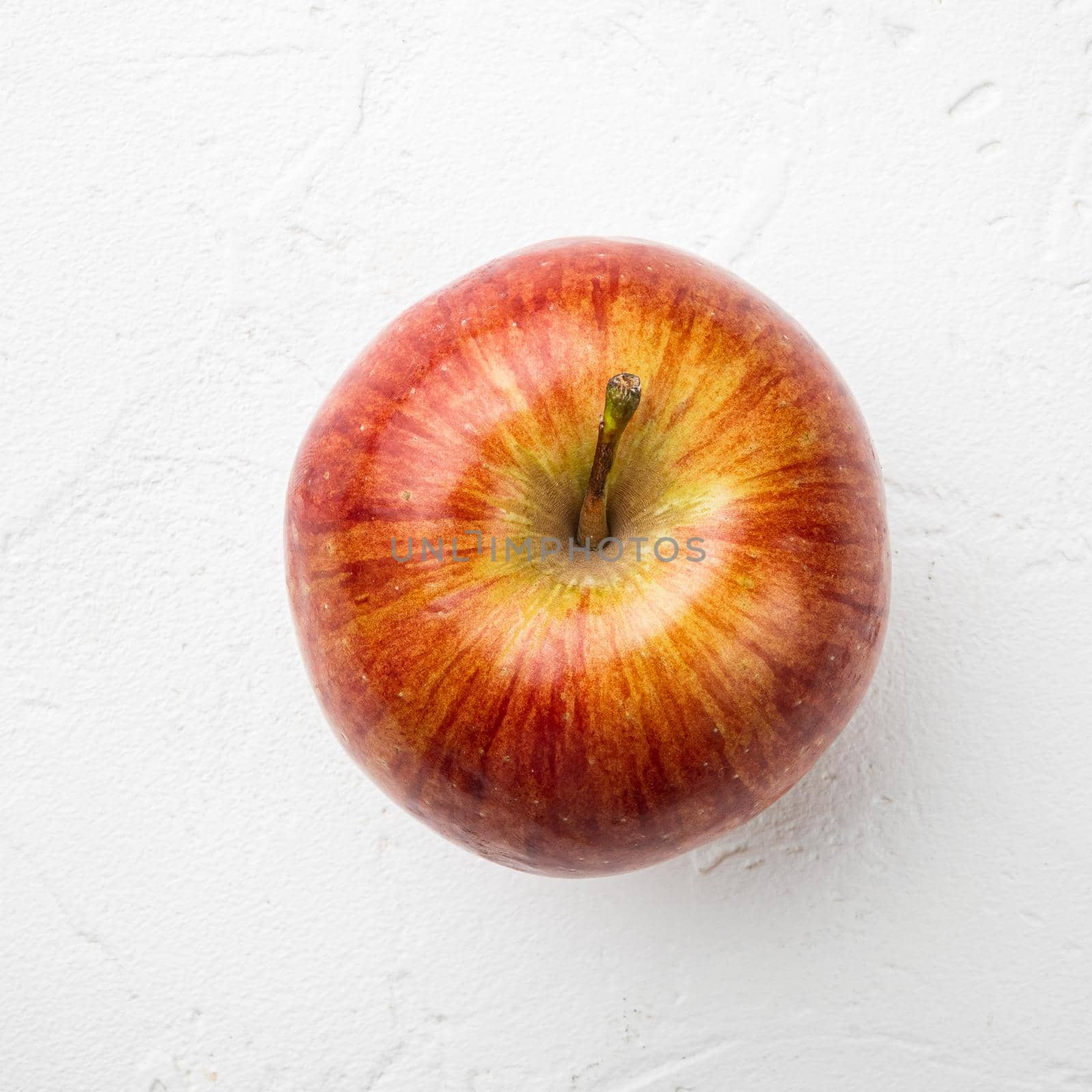 Red apple, on white stone table background, square format, top view flat lay by Ilianesolenyi