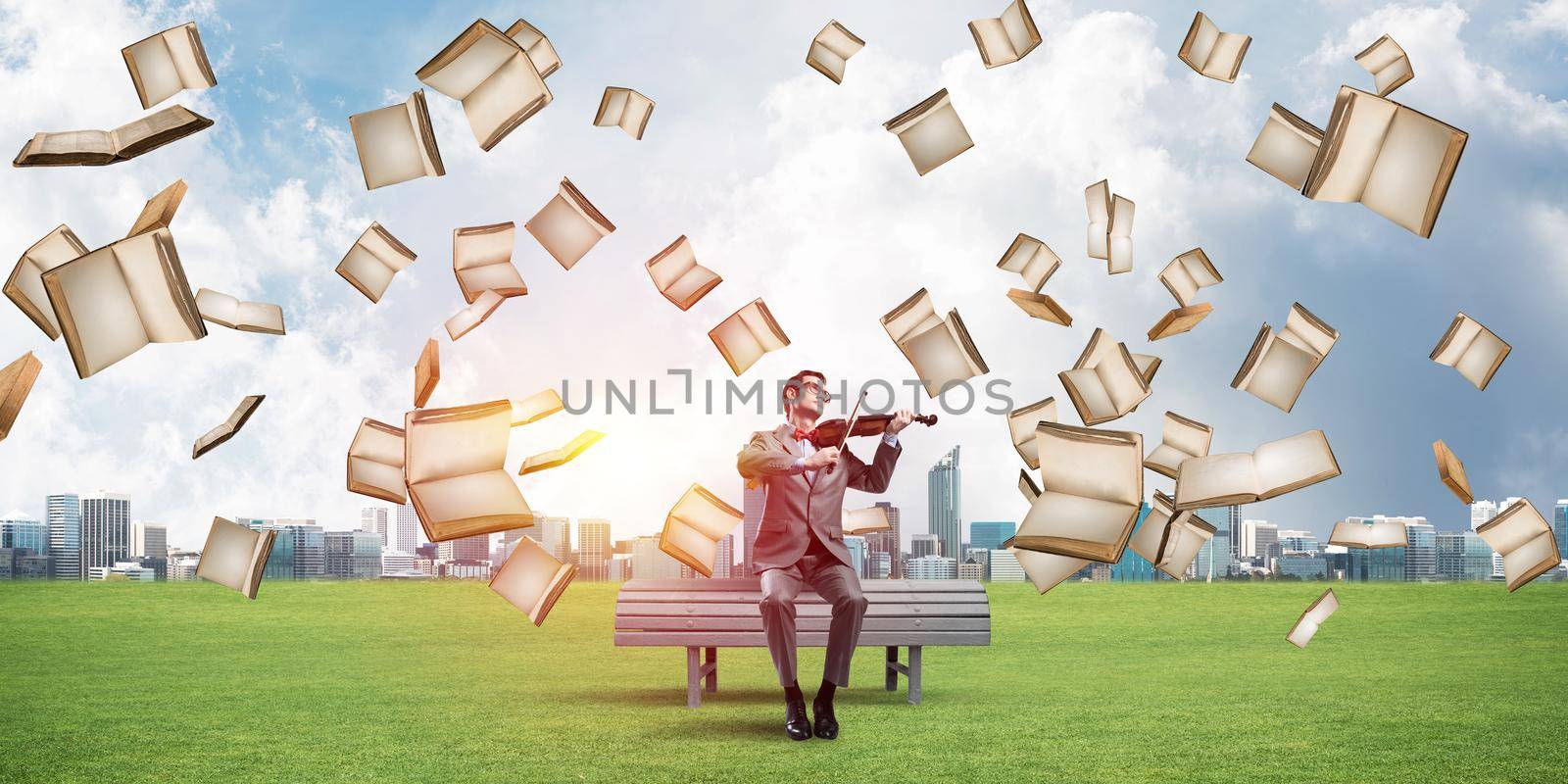 Young man wearing suit and glasses sitting on bench and playing violin