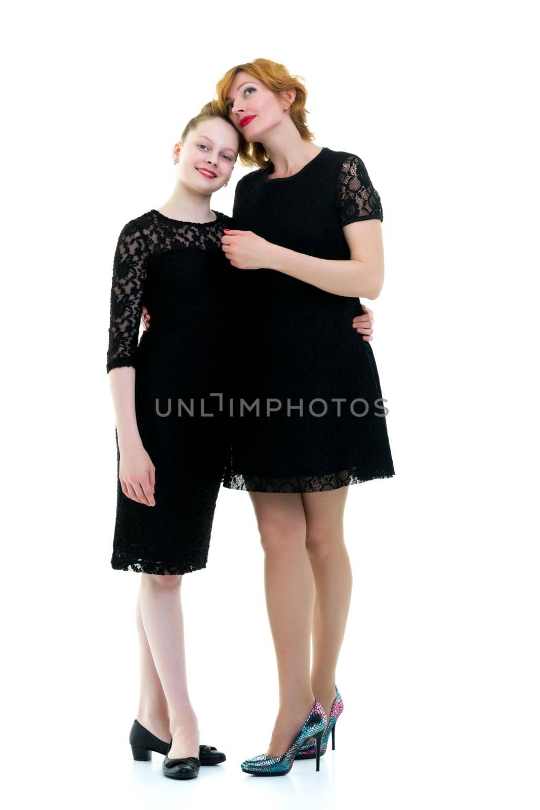 Mom and little daughter studio portrait on a white background. by kolesnikov_studio