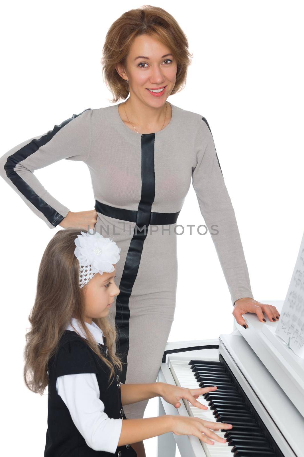 The girl at the music school diligently learn to play piano music , which gave her music teacher - Isolated on white background