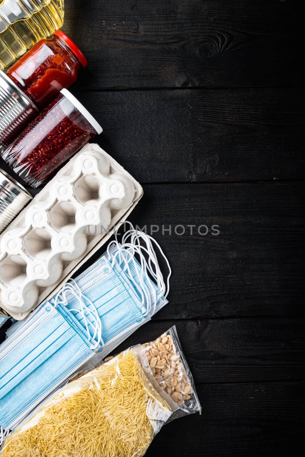 Set of food products. Food supplies. Donation, coronavirus quarantine concept, top view with copy space, on black wooden table