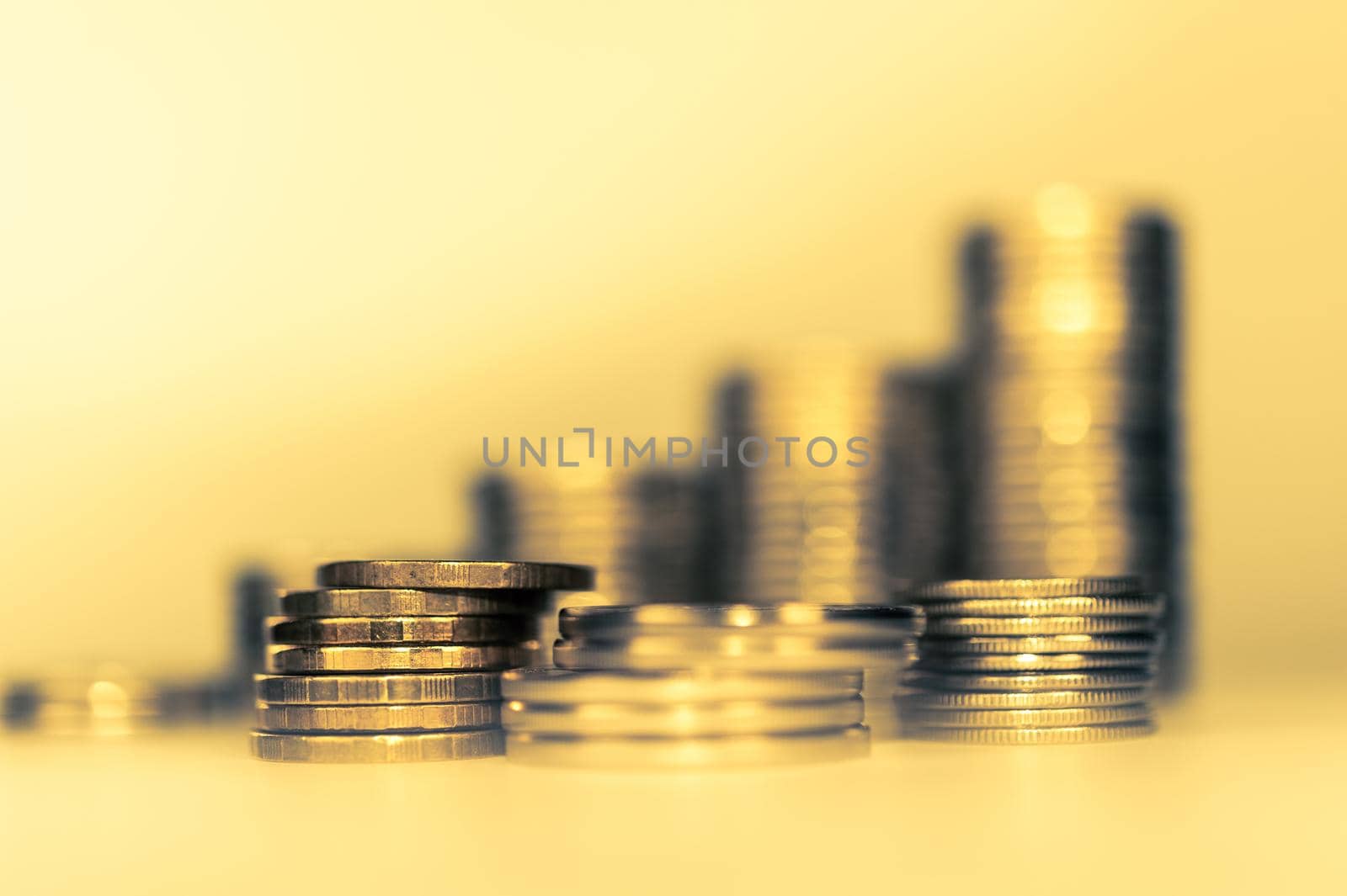 Stack of golden coins macro. Rows of coins for finance and banking concept. Economy trends background for business idea and all art work design. Closeup, Shallow depth of field. Toned.