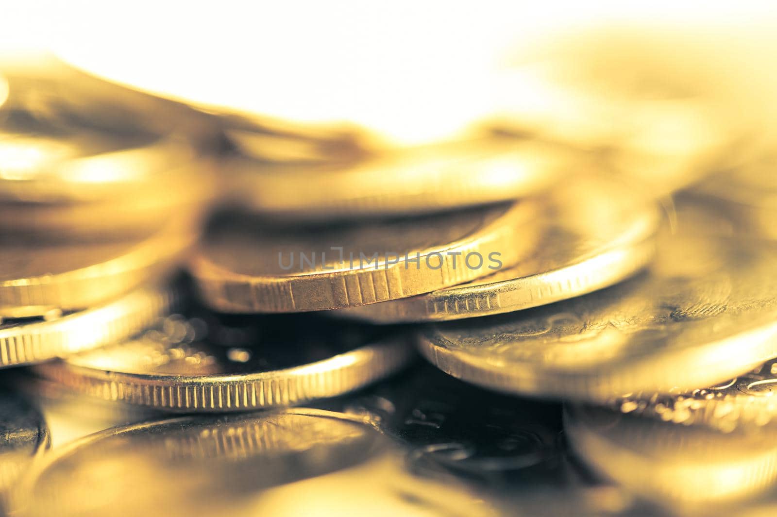 Stack of golden coins macro. Rows of coins for finance and banking concept. Economy trends background for business idea and all art work design. Closeup, Shallow depth of field. Toned.