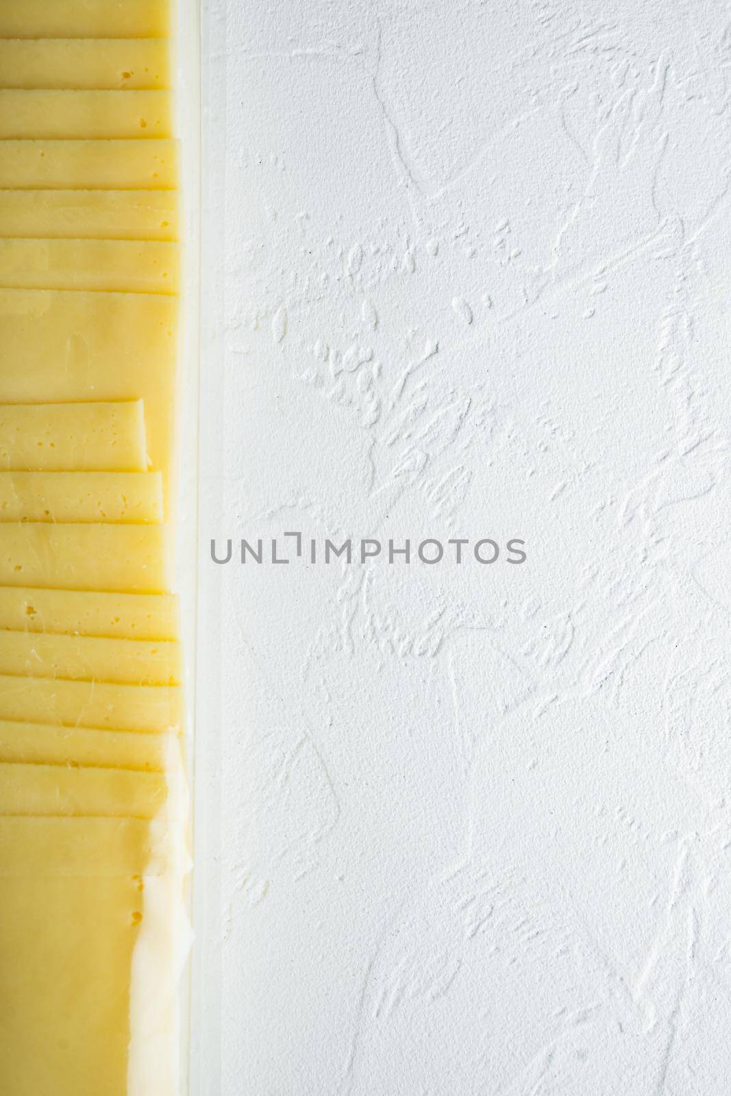 Slices of american cheese plastic pack, on white background with copy space for text