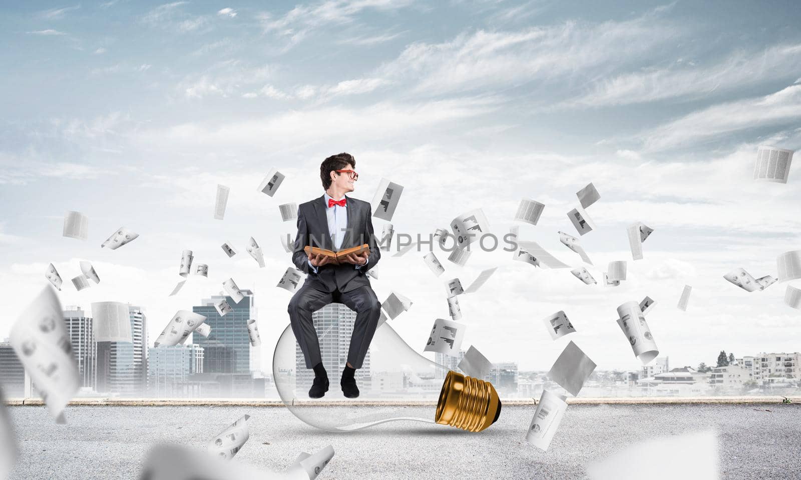 young businessman with a book. flying around papers in chaos