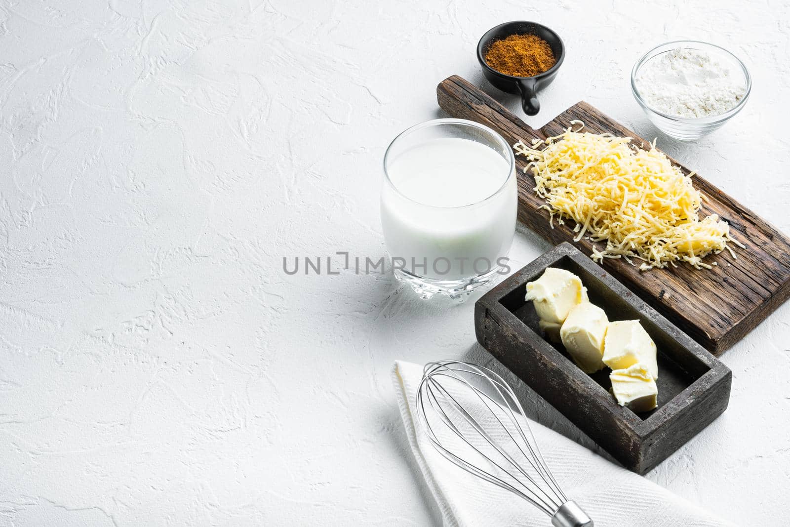 White Bechamel sauce ingredients set, on white stone background, with copy space for text