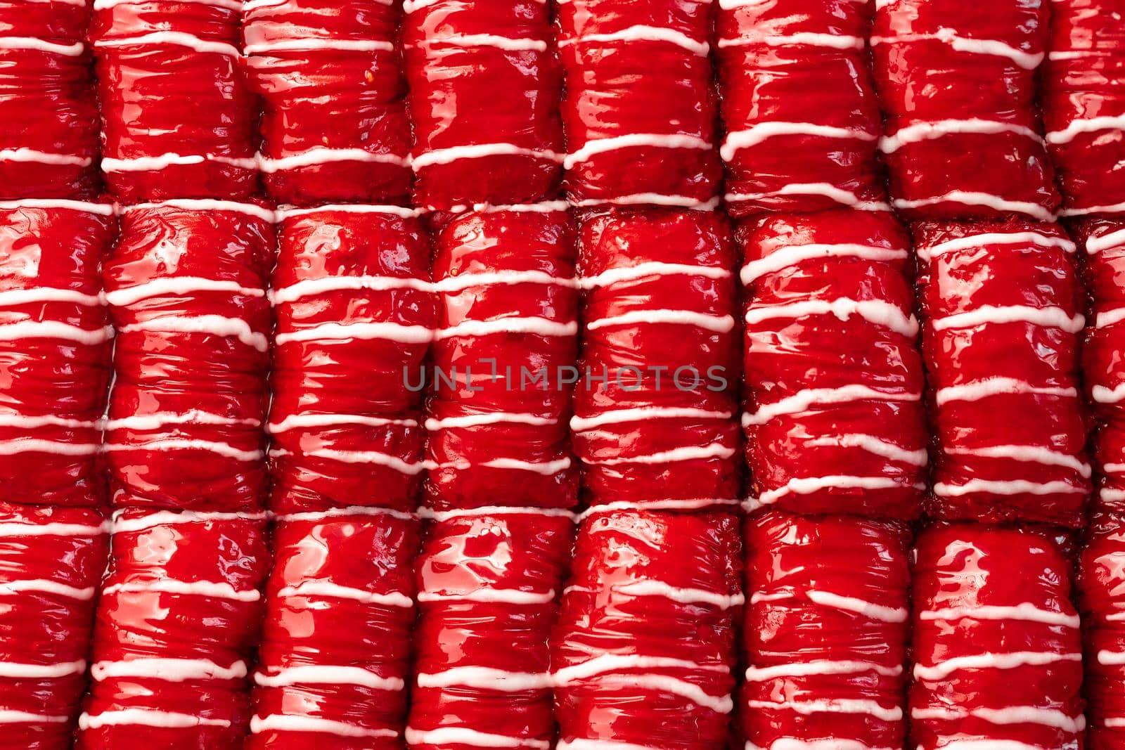 Red colored Turkish dessert baklava placed in rows, for background