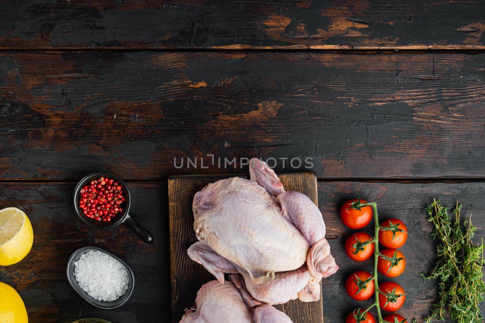 Fresh raw chicken meat with ingredients, on old wooden table, top view with copy space for text