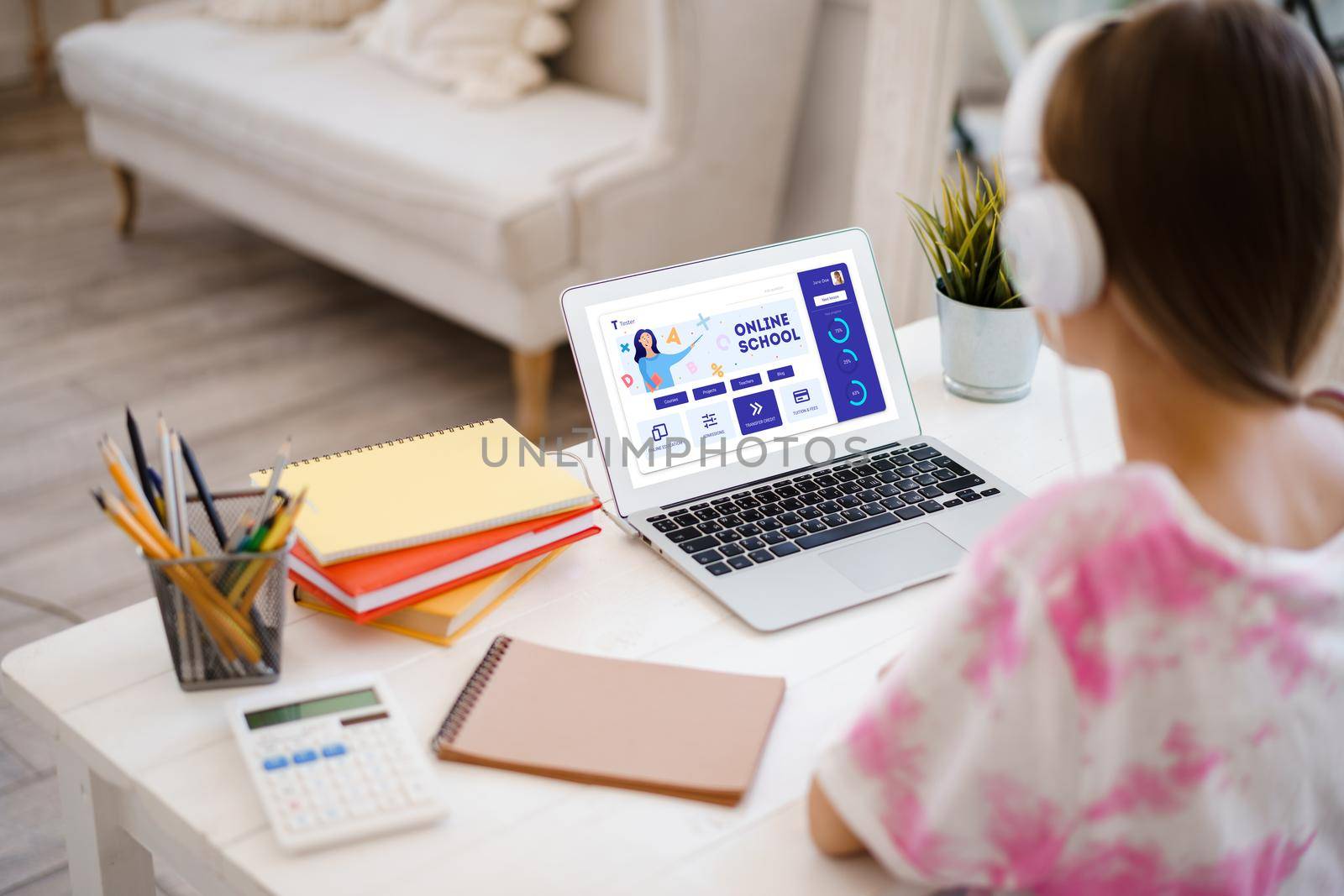 Girl student e-learning distance training course, study at home on laptop, view from back