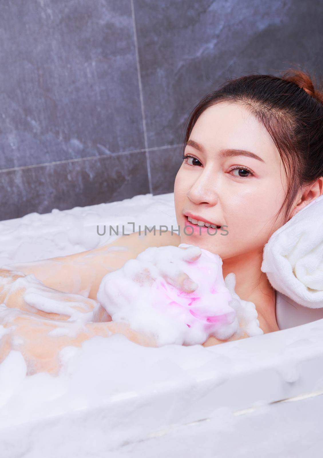 woman relaxing in the bathtub in the bathroom by geargodz