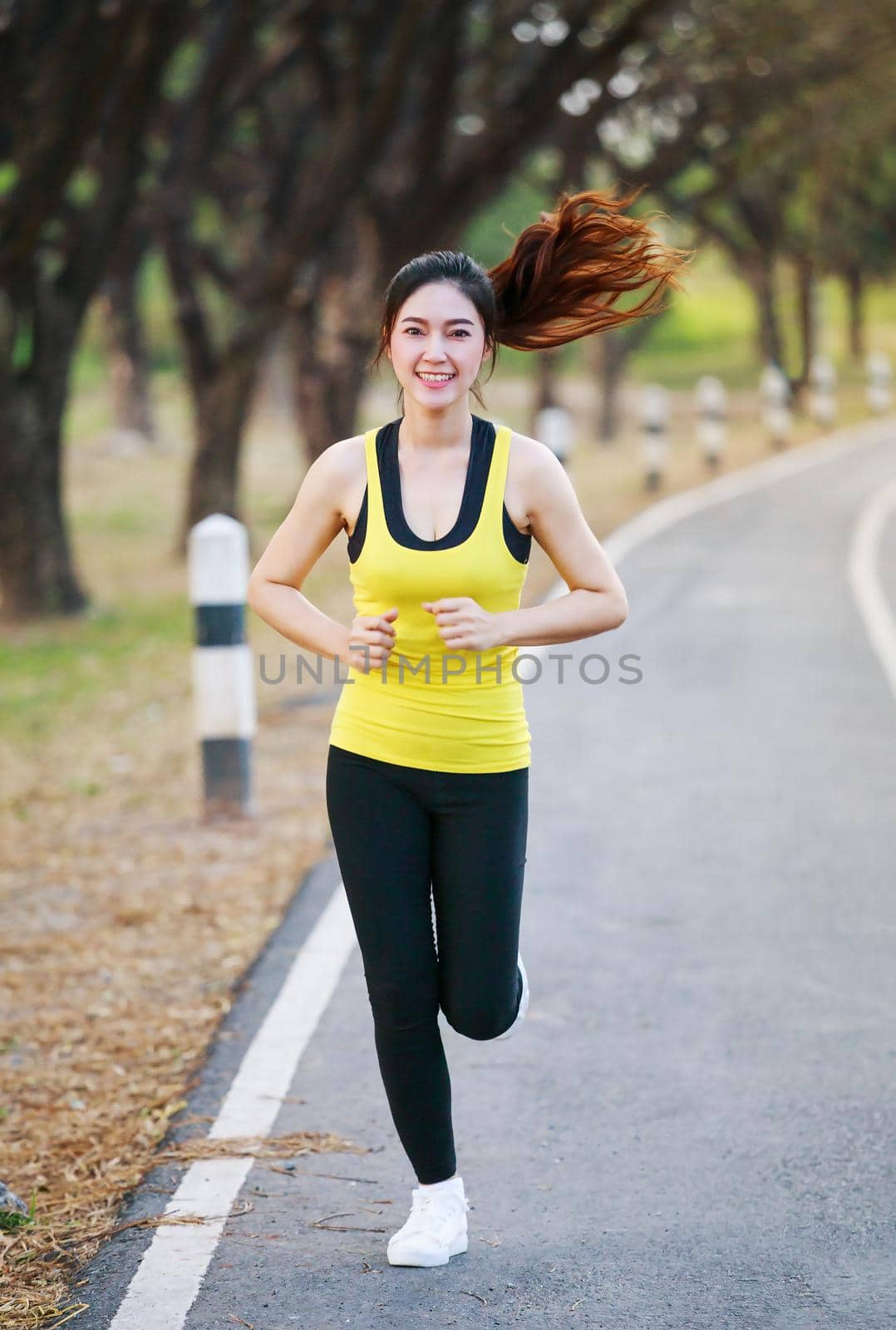 beautiful fitness woman running in park by geargodz