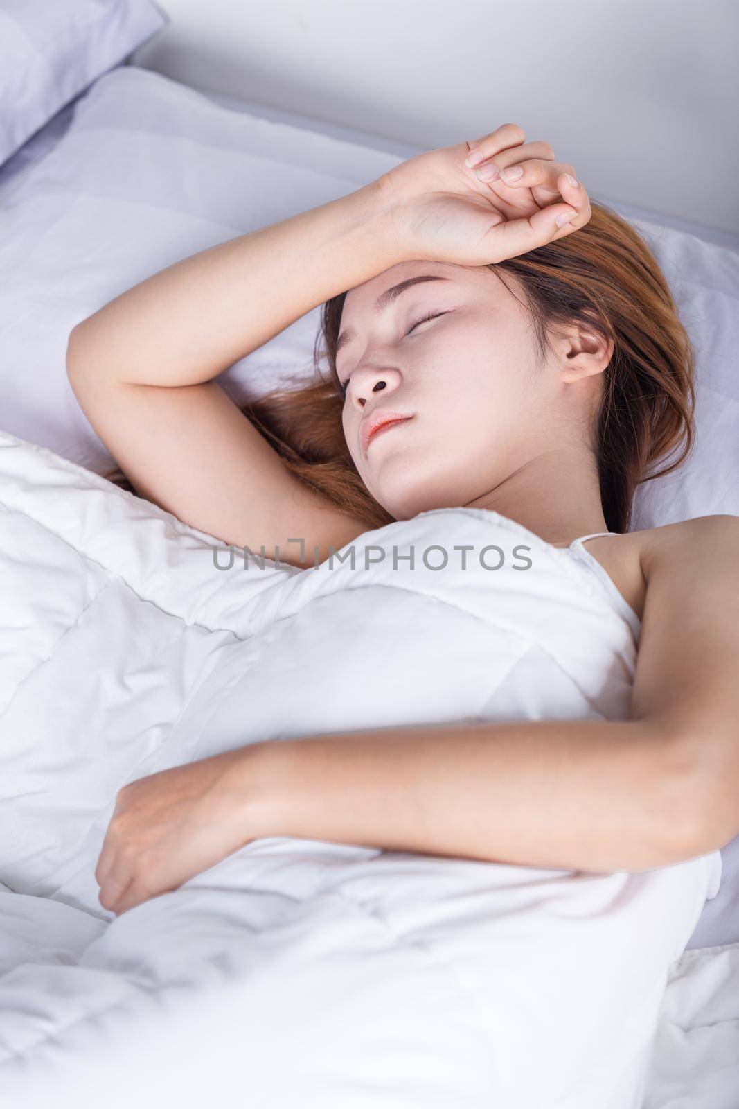 Woman sleeping on bed in the bedroom 