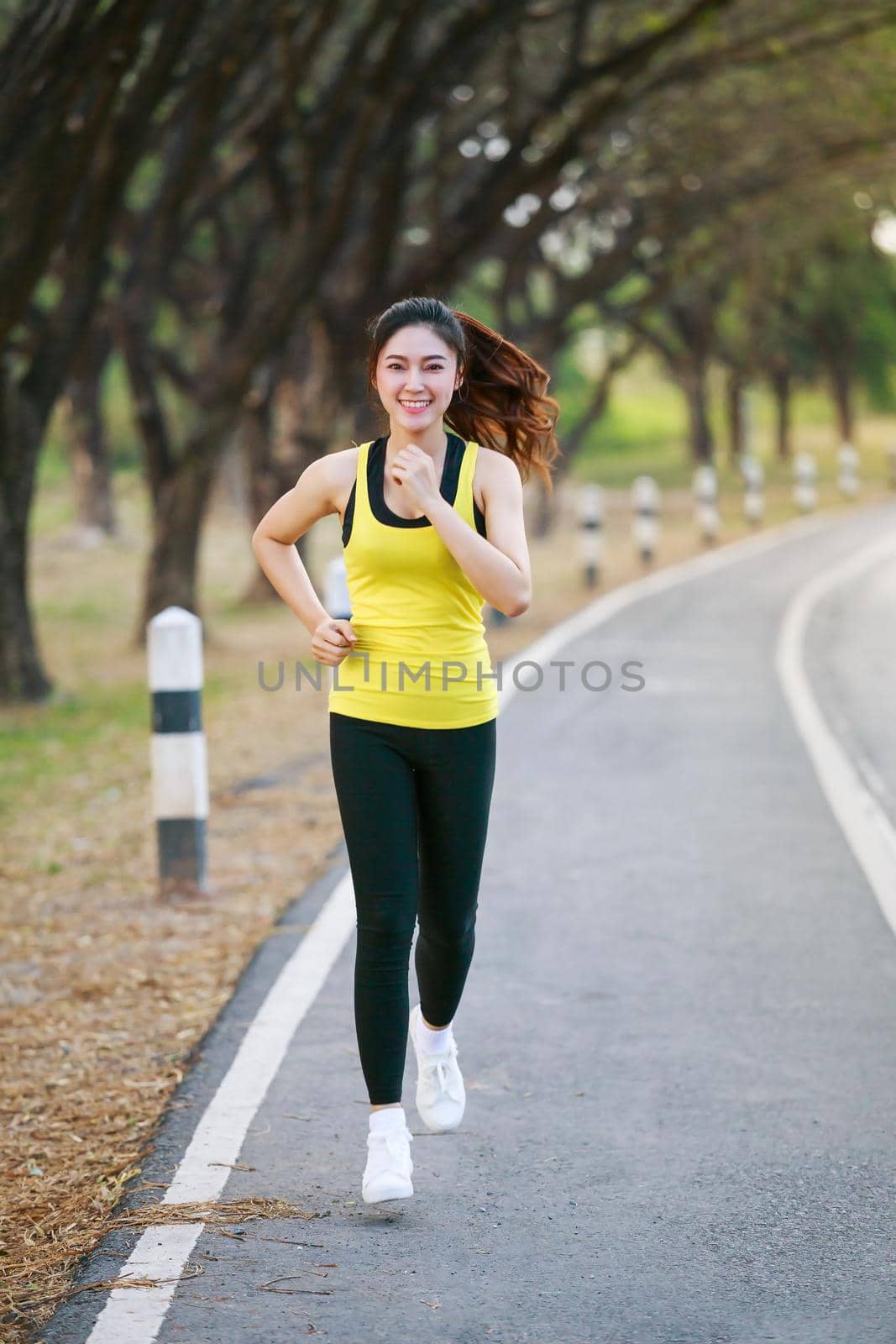 beautiful fitness woman running in park by geargodz