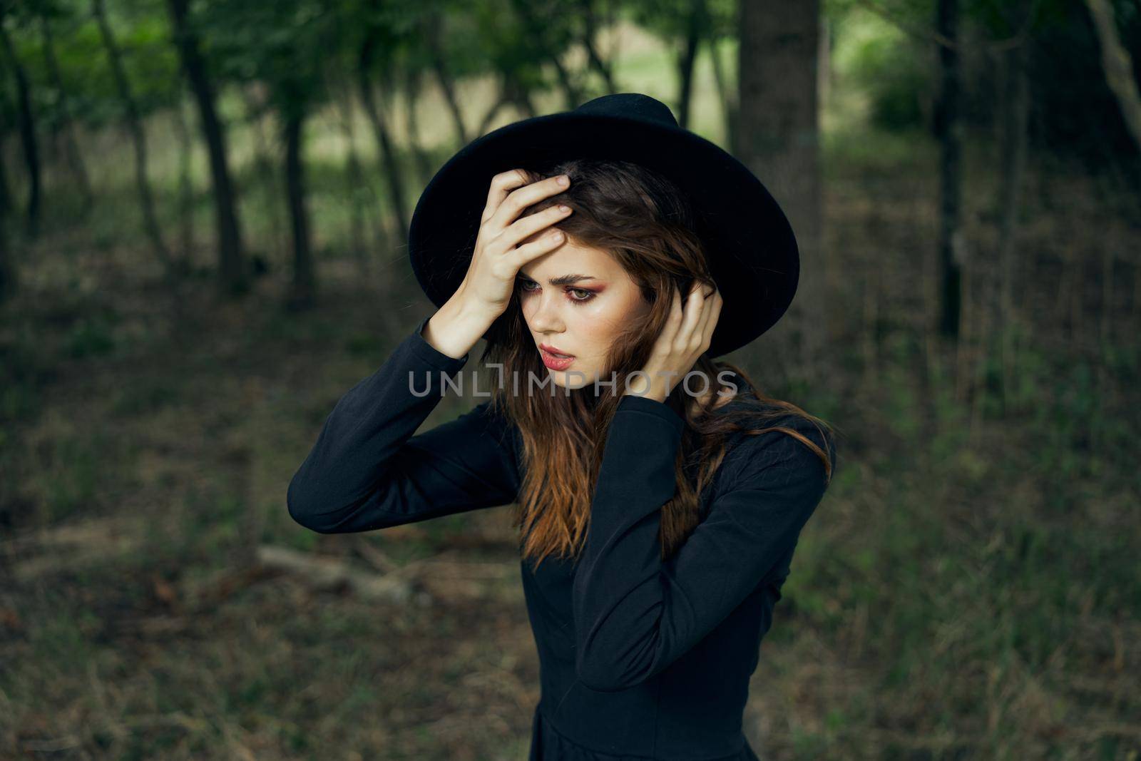 woman witch in black hat in the forest posing fantasy by Vichizh